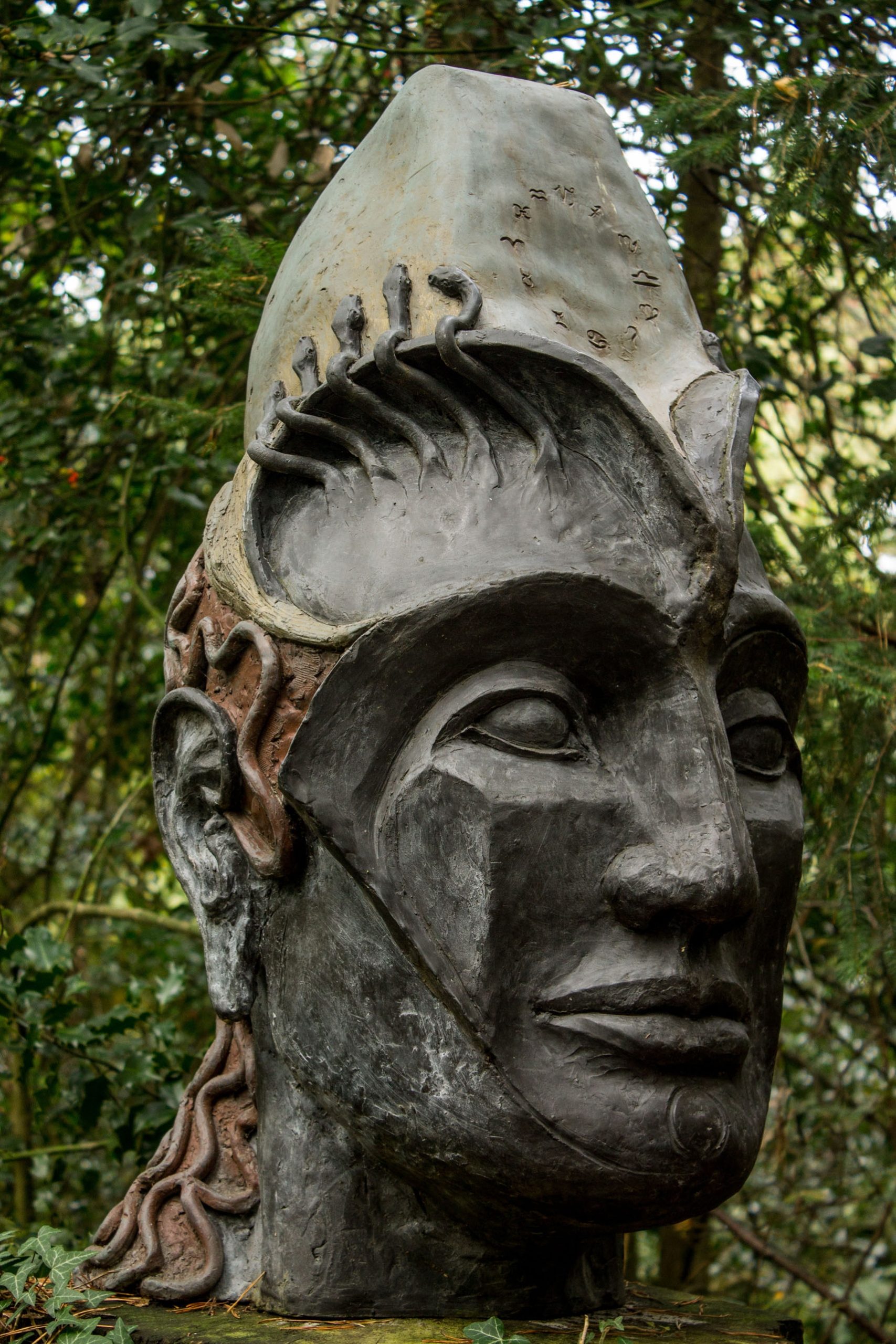 A figurative bronze resin sculpture of a portrait of a mans head.