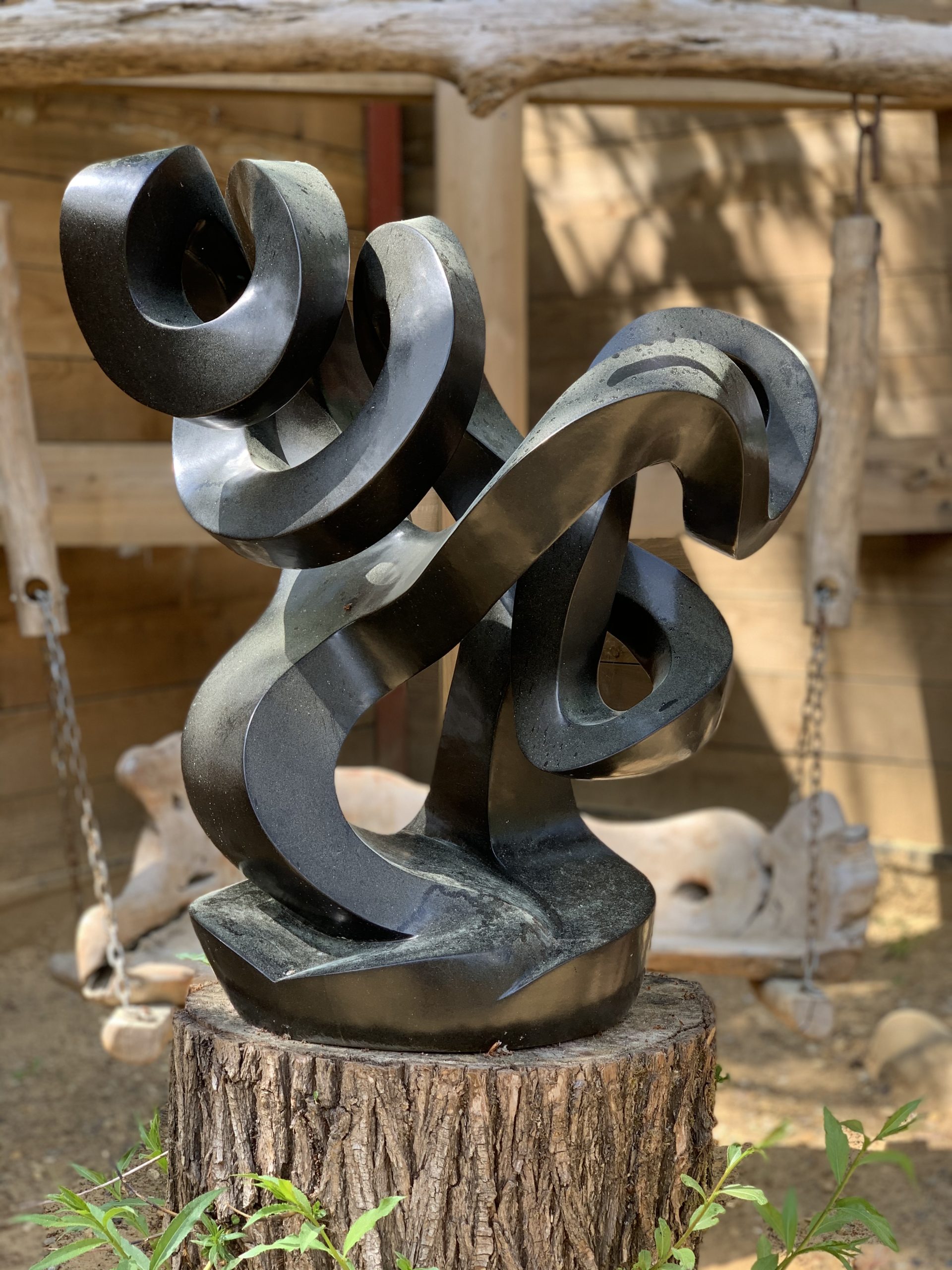 A abstract Shona springstone sculpture depicting twisting and curving shape.