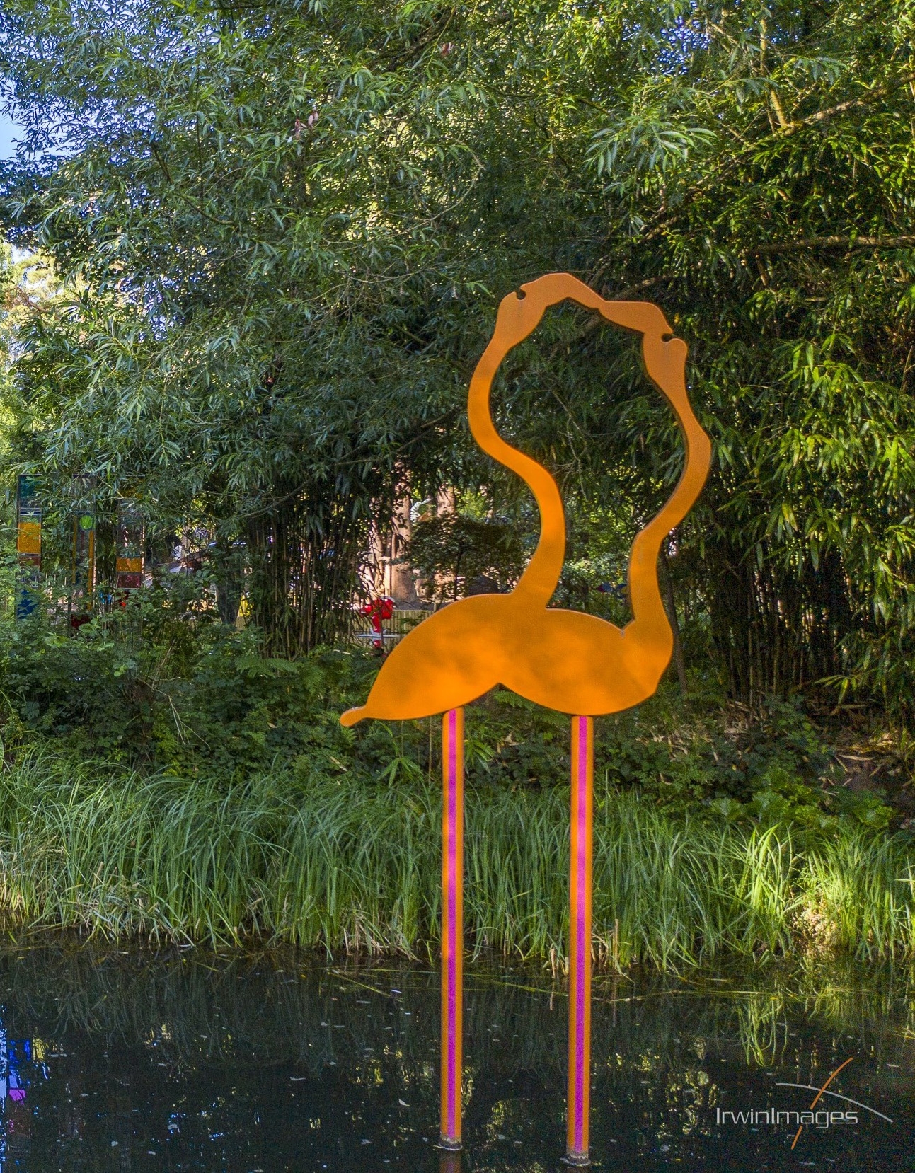 A figurative Powder Coated Steel sculpture of a pair of yellow flamingos together.