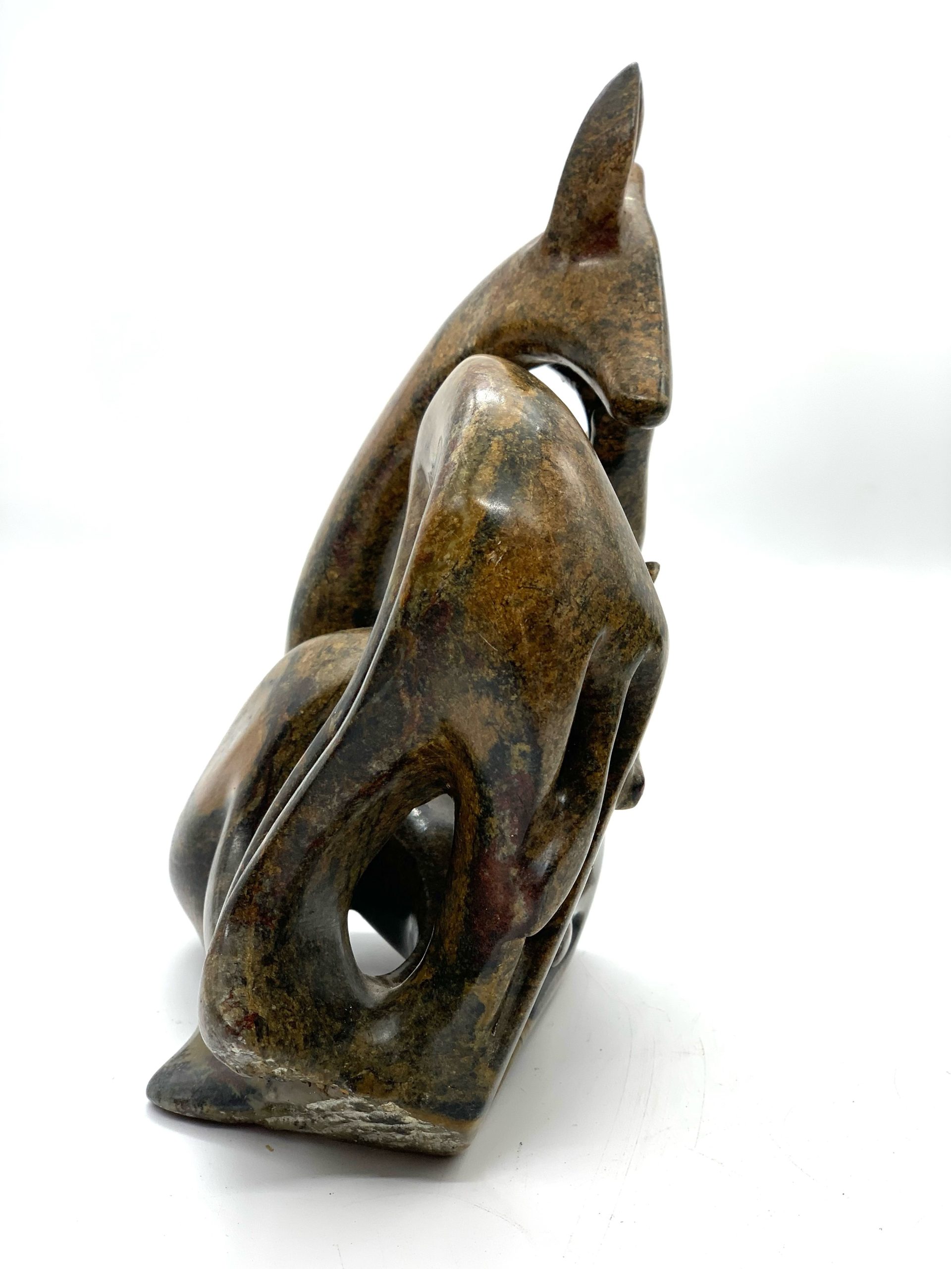 Zimbabwean Shona Serpentine Stone sculpture of a Family of Giraffes, Huddled Together in a Knot