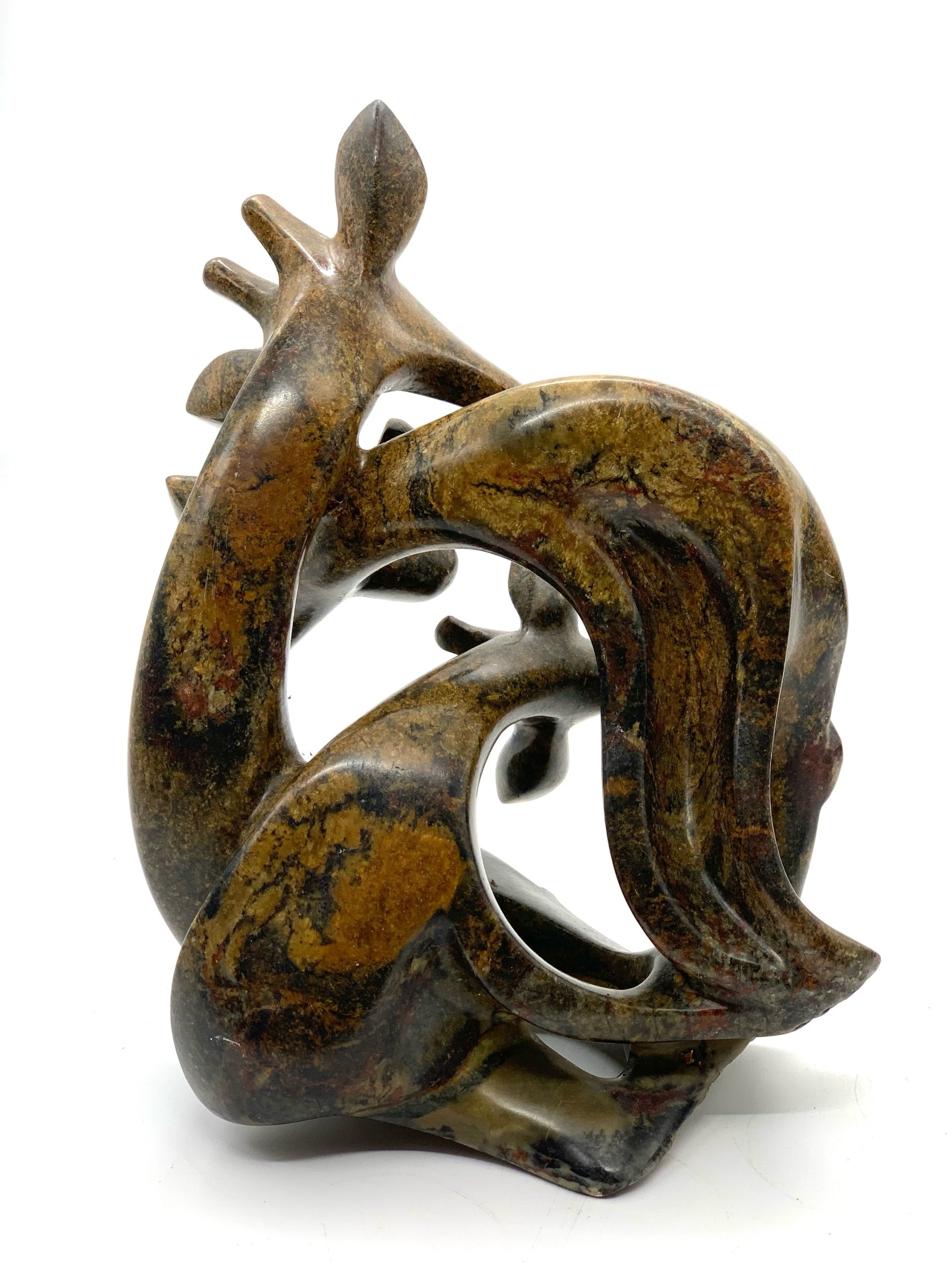 Zimbabwean Shona Serpentine Stone sculpture of a Family of Giraffes, Huddled Together in a Knot