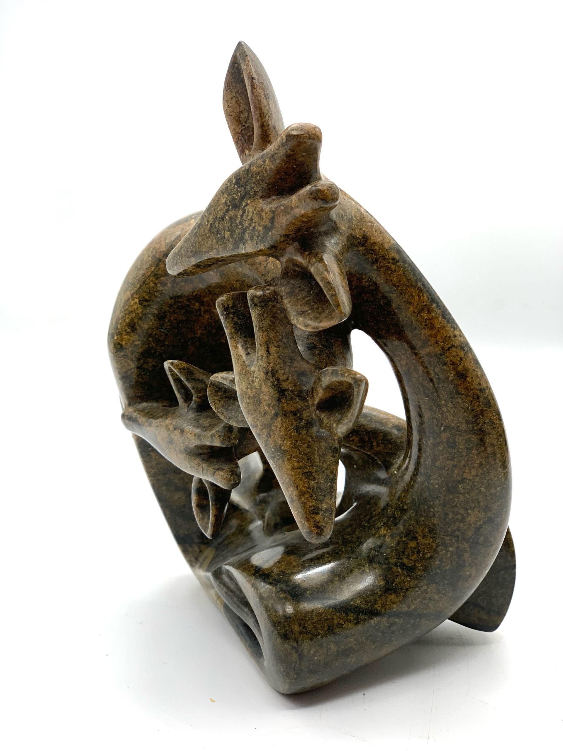 Zimbabwean Shona Serpentine Stone sculpture of a Family of Giraffes, Huddled Together in a Knot