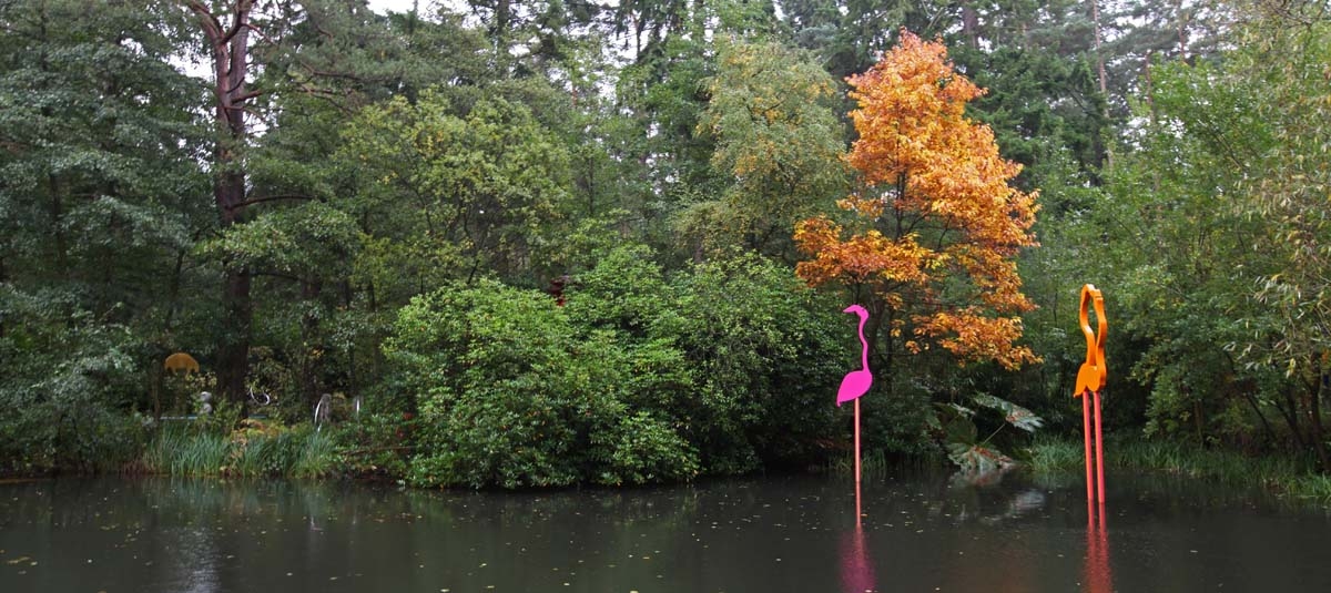 A figurative Powder Coated Steel sculpture of a pair of yellow flamingos together.