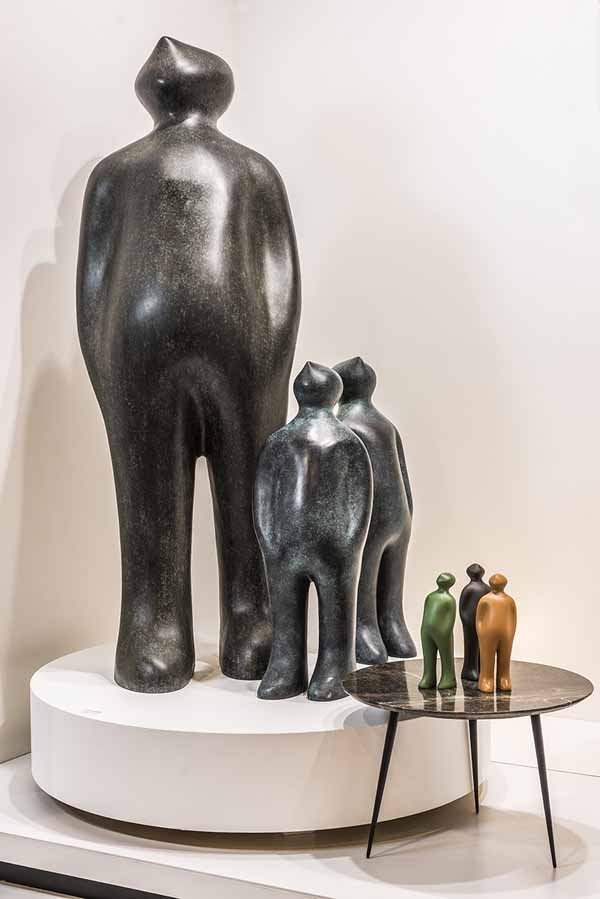 A figurative sculpture of a figure standing and looking upwards.