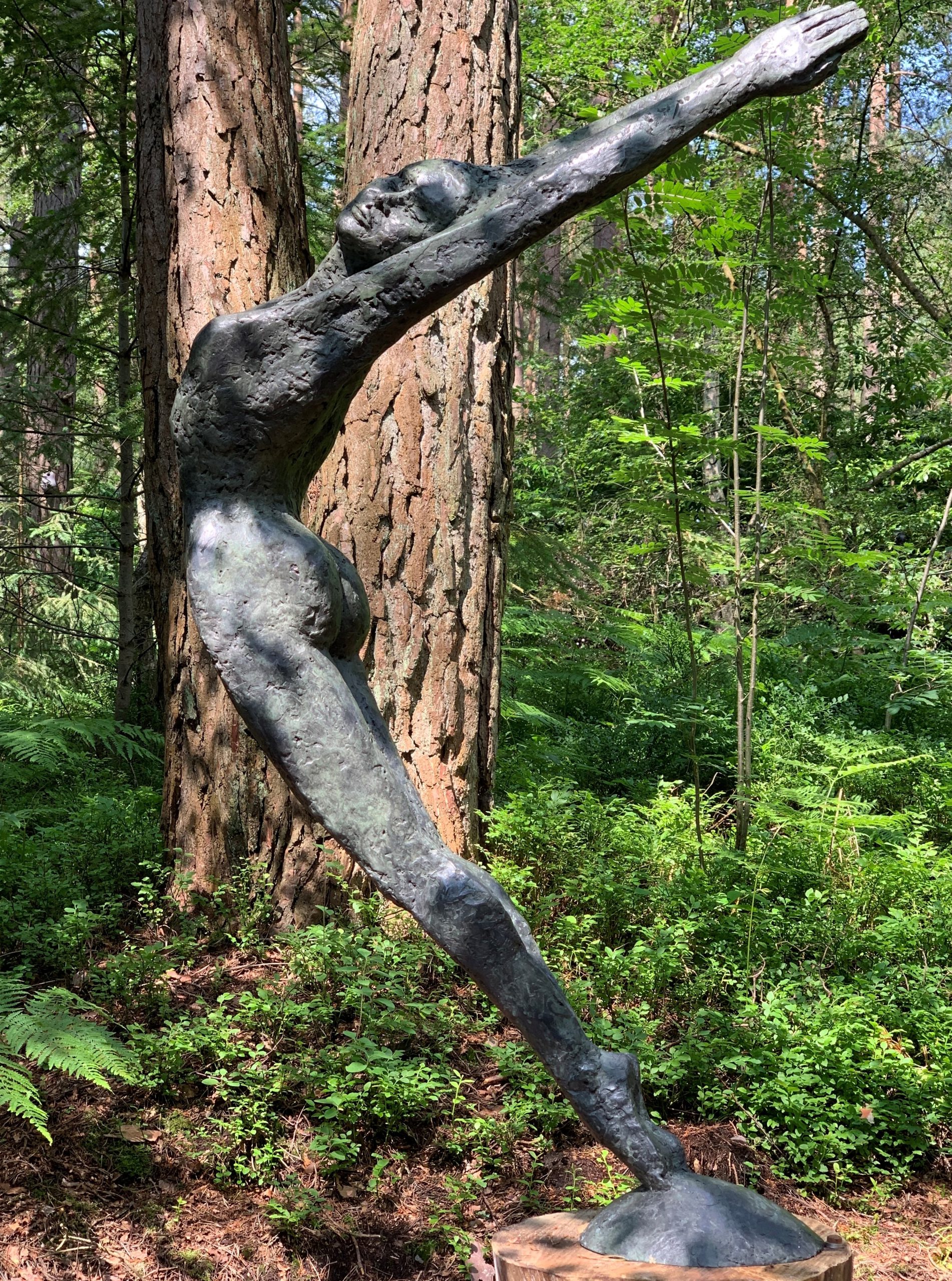 Figurative Bronze Sculpture of a Woman with Arms in the Air, Leaning Back