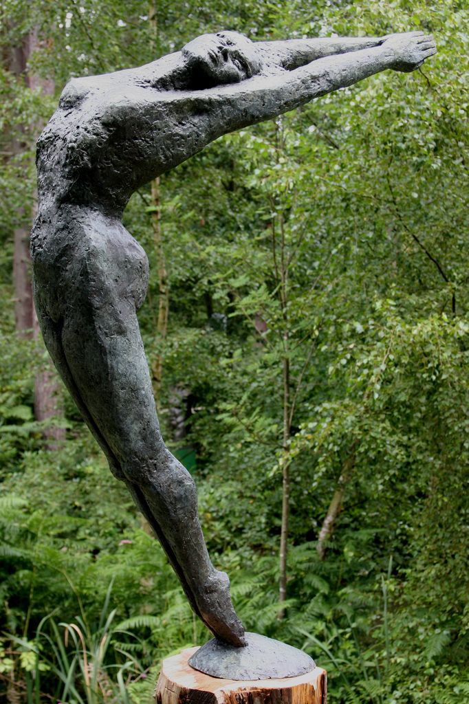 Figurative Bronze Sculpture of a Woman with Arms in the Air, Leaning Back