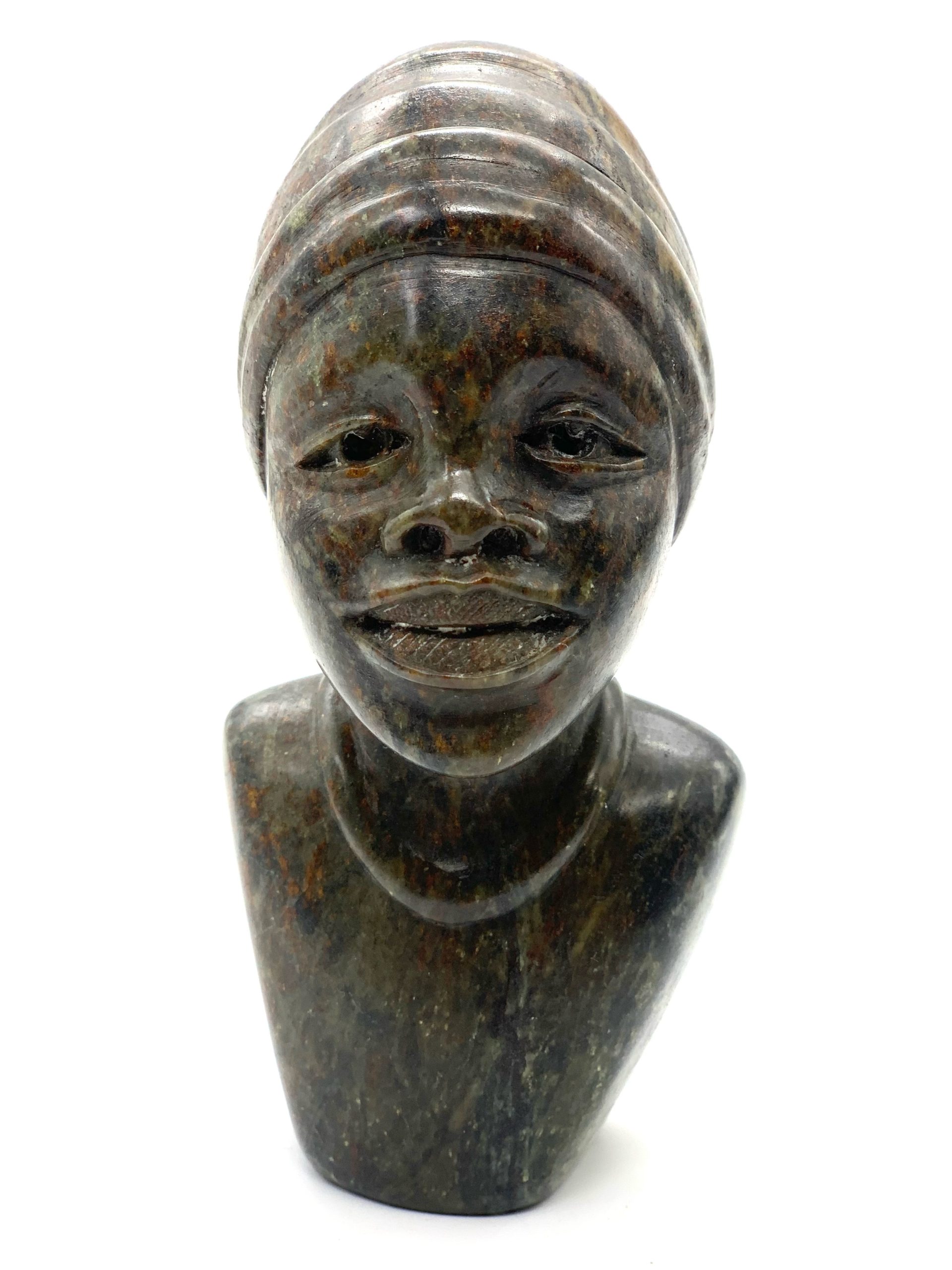 A smaller scale Shona sculpture of a smiling female bust.
