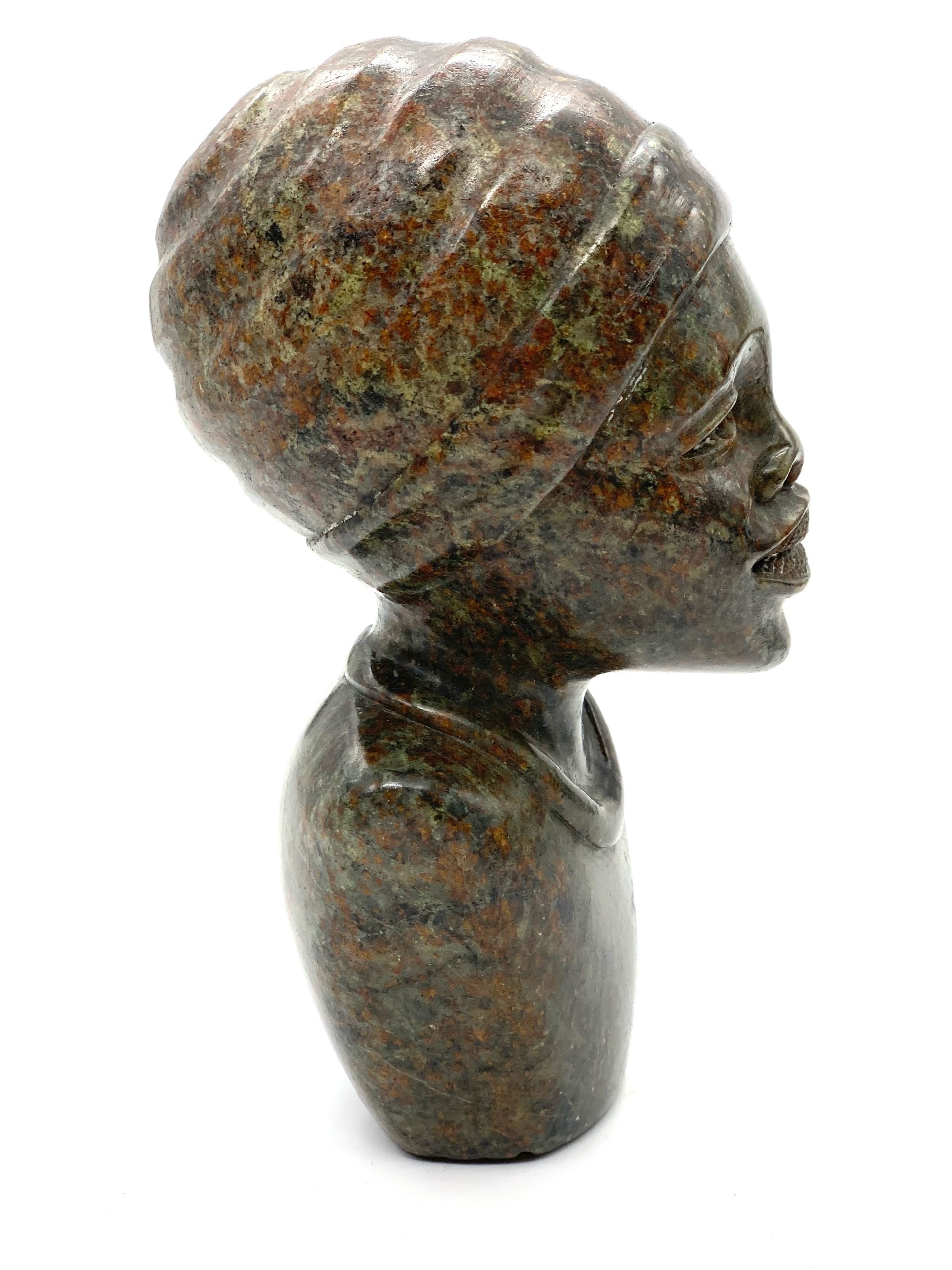 A smaller scale Shona sculpture of a smiling female bust.