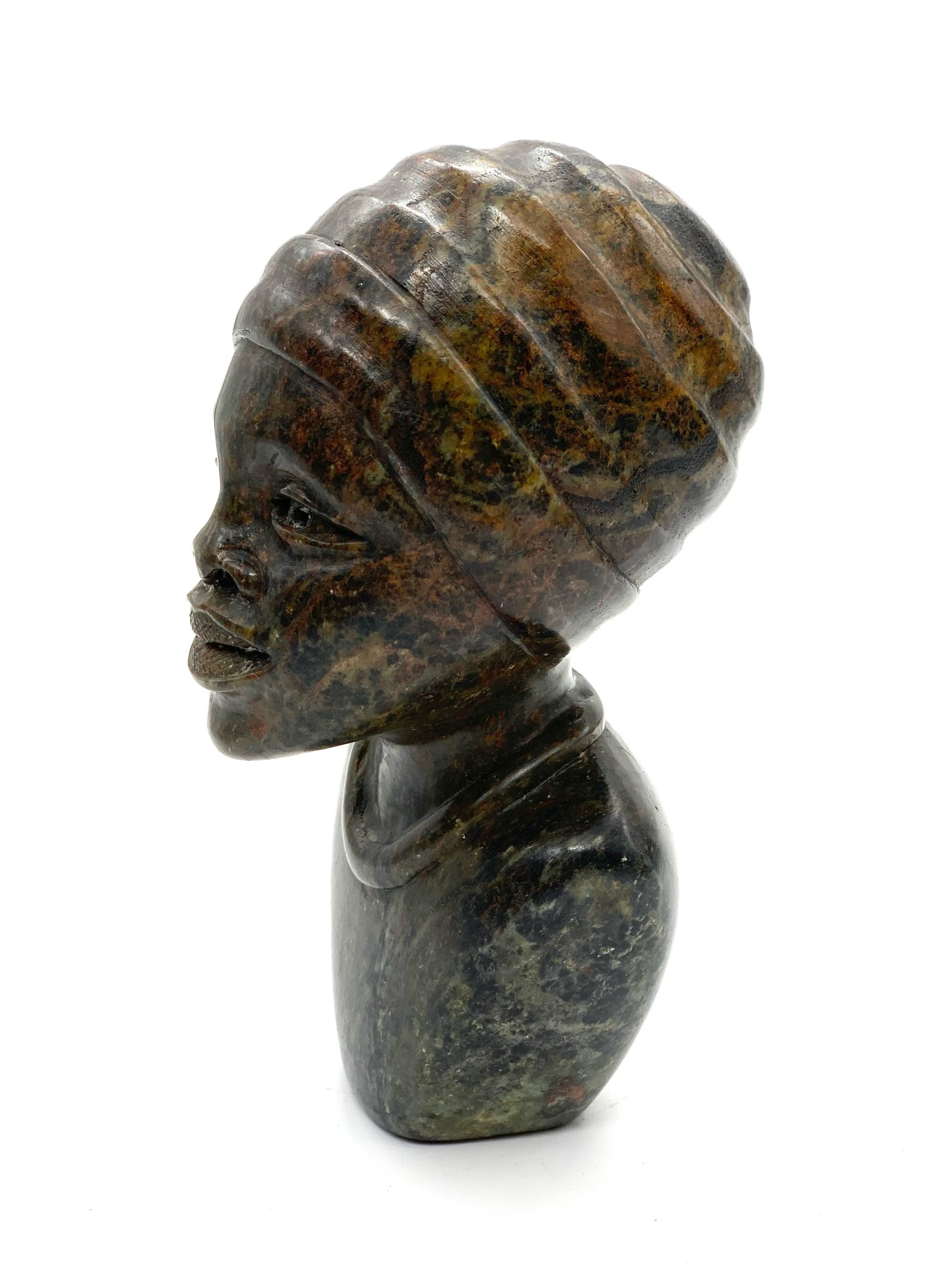 A smaller scale Shona sculpture of a smiling female bust.