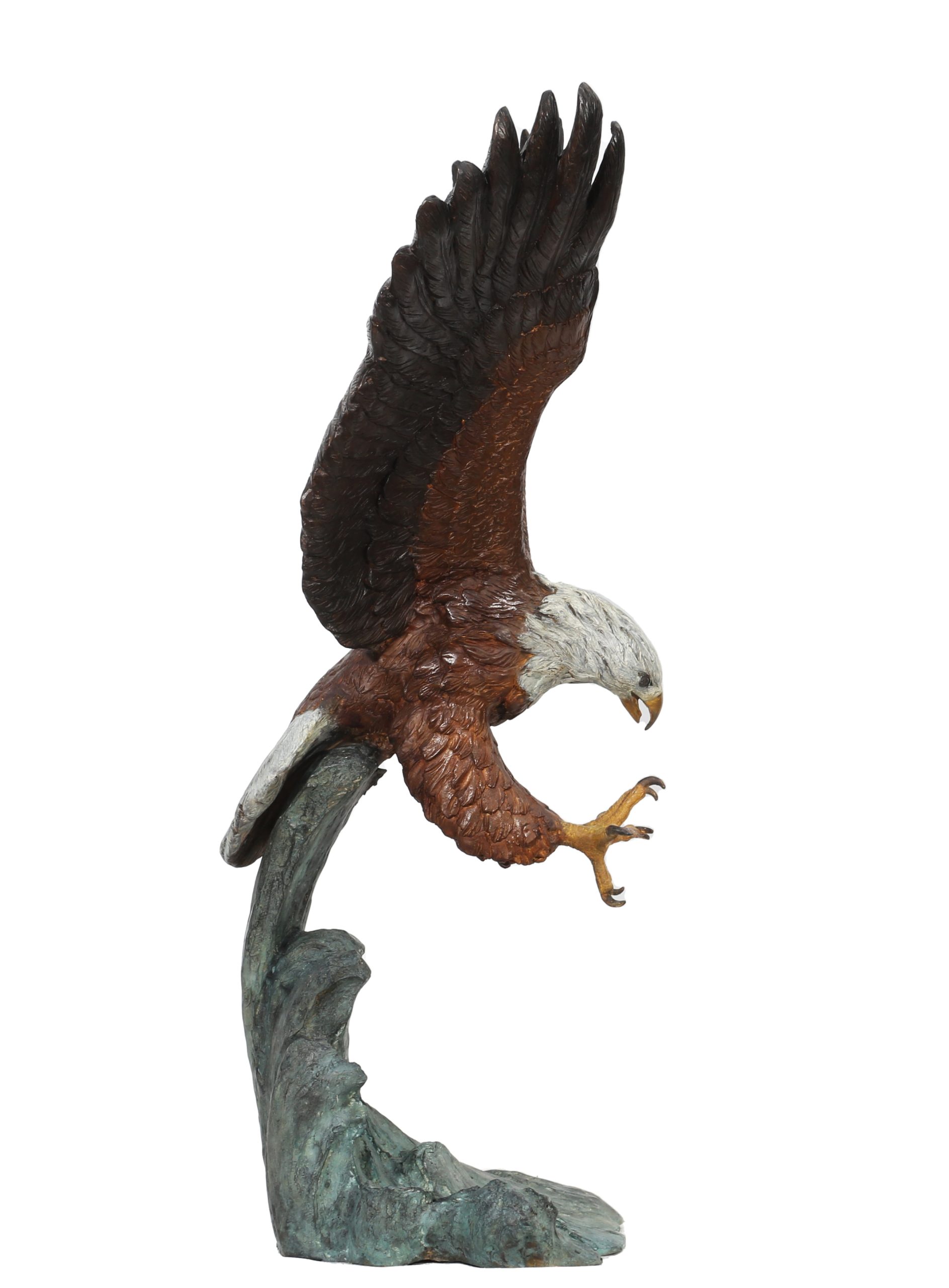 A figurative painted bronze sculpture of a bald eagle with its wings and talons outstretched, catching its prey.