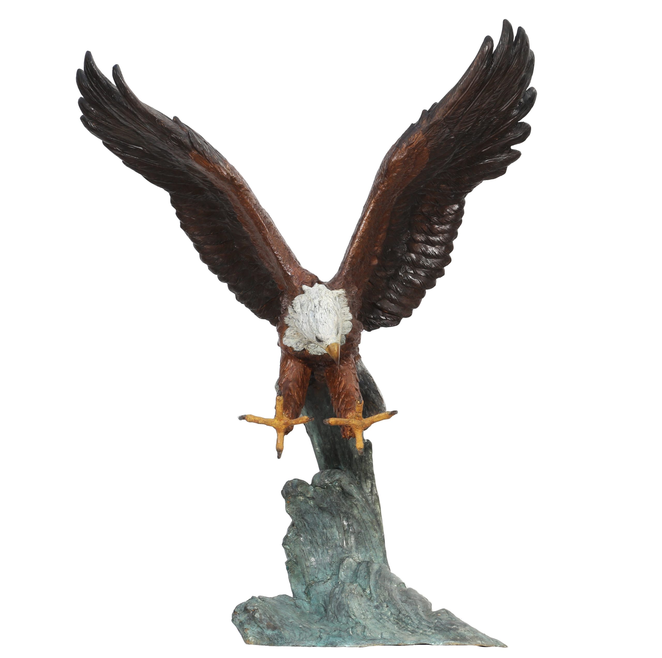 A figurative painted bronze sculpture of a bald eagle with its wings and talons outstretched, catching its prey.