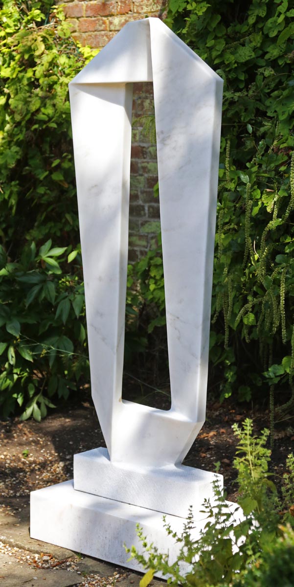 A abstract marble sculpture of a band wrapped around into a rectangle shape.