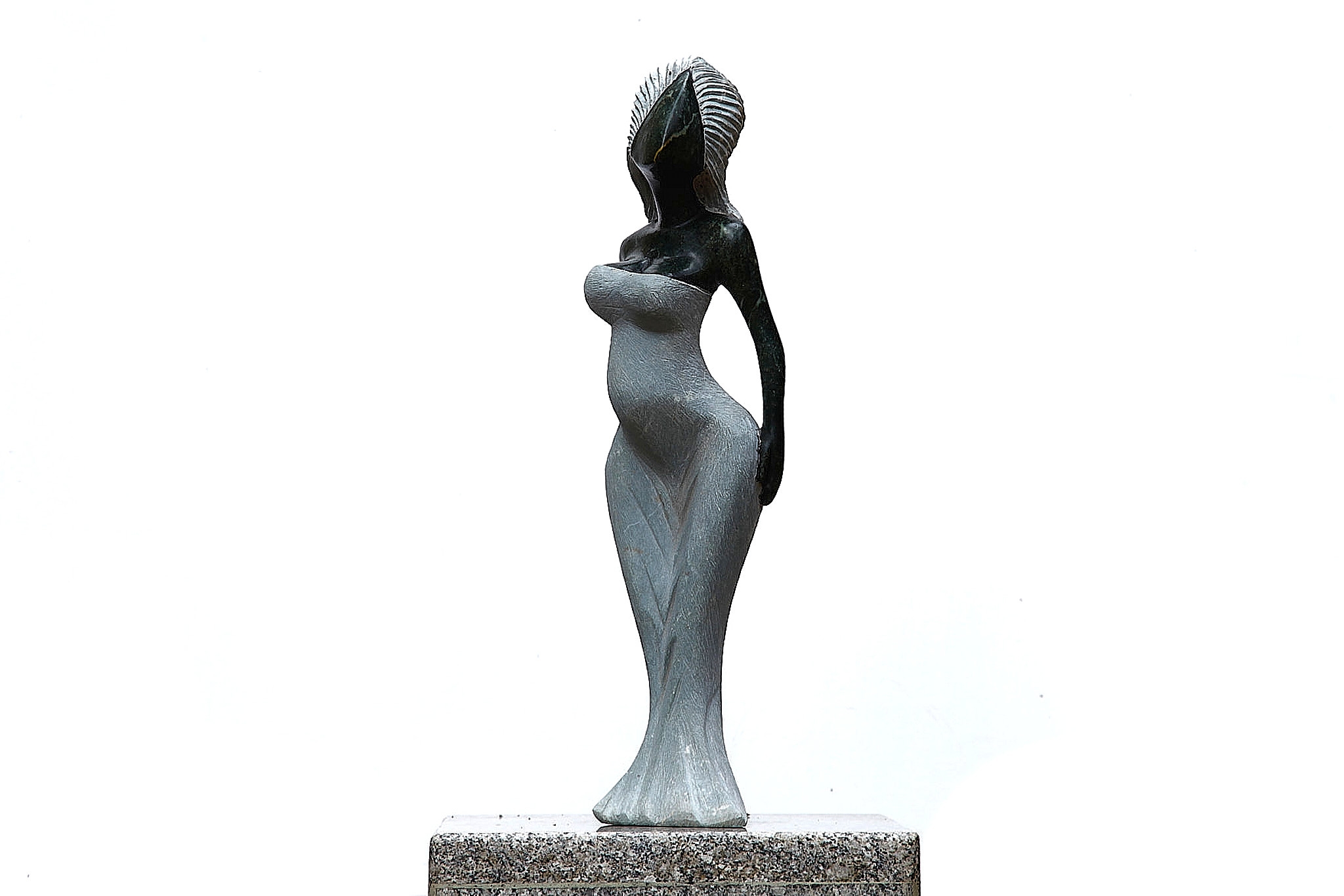 A Shona sculpture made of Opal stone of a woman in a dress.