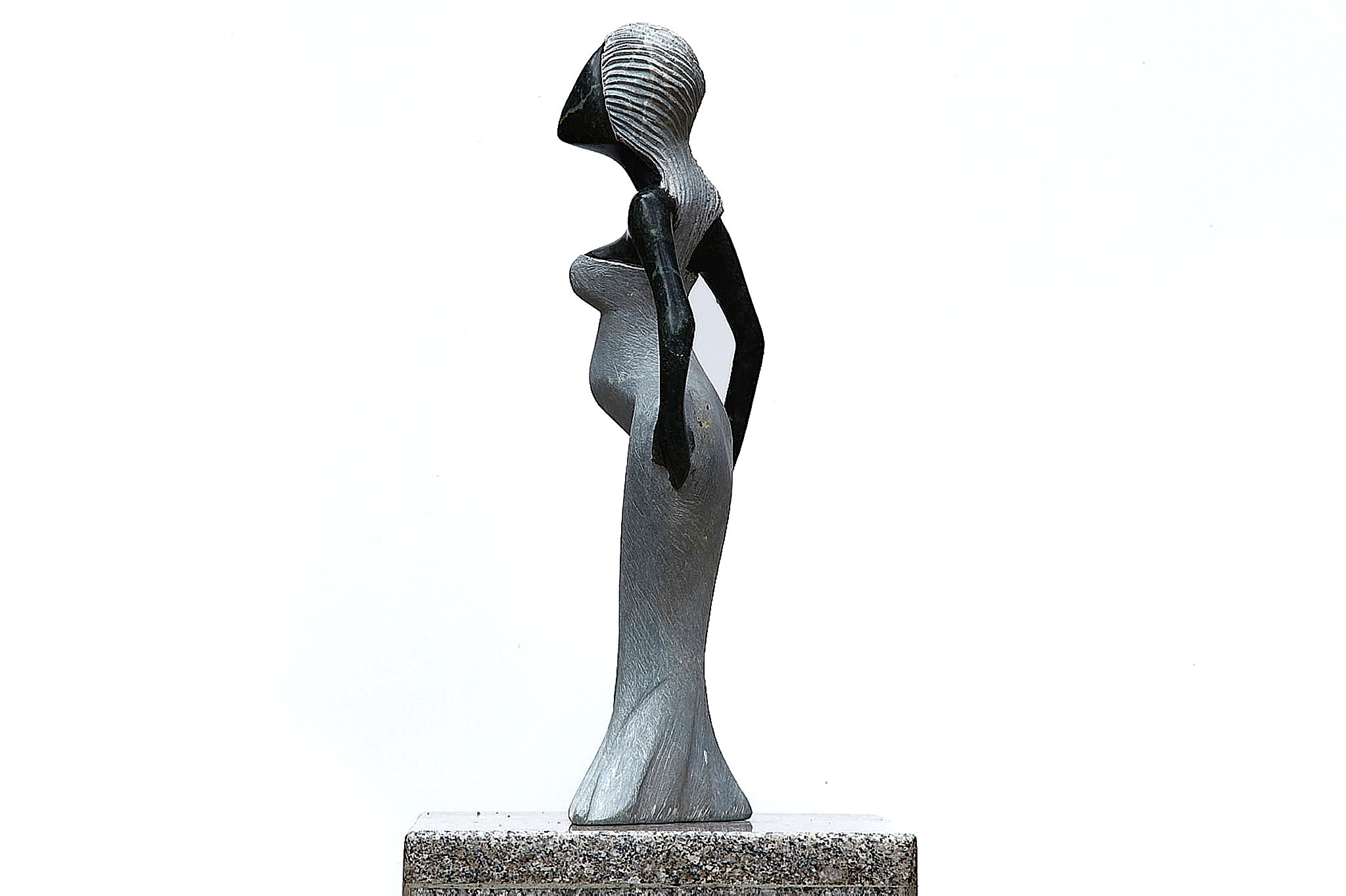 A Shona sculpture made of Opal stone of a woman in a dress.