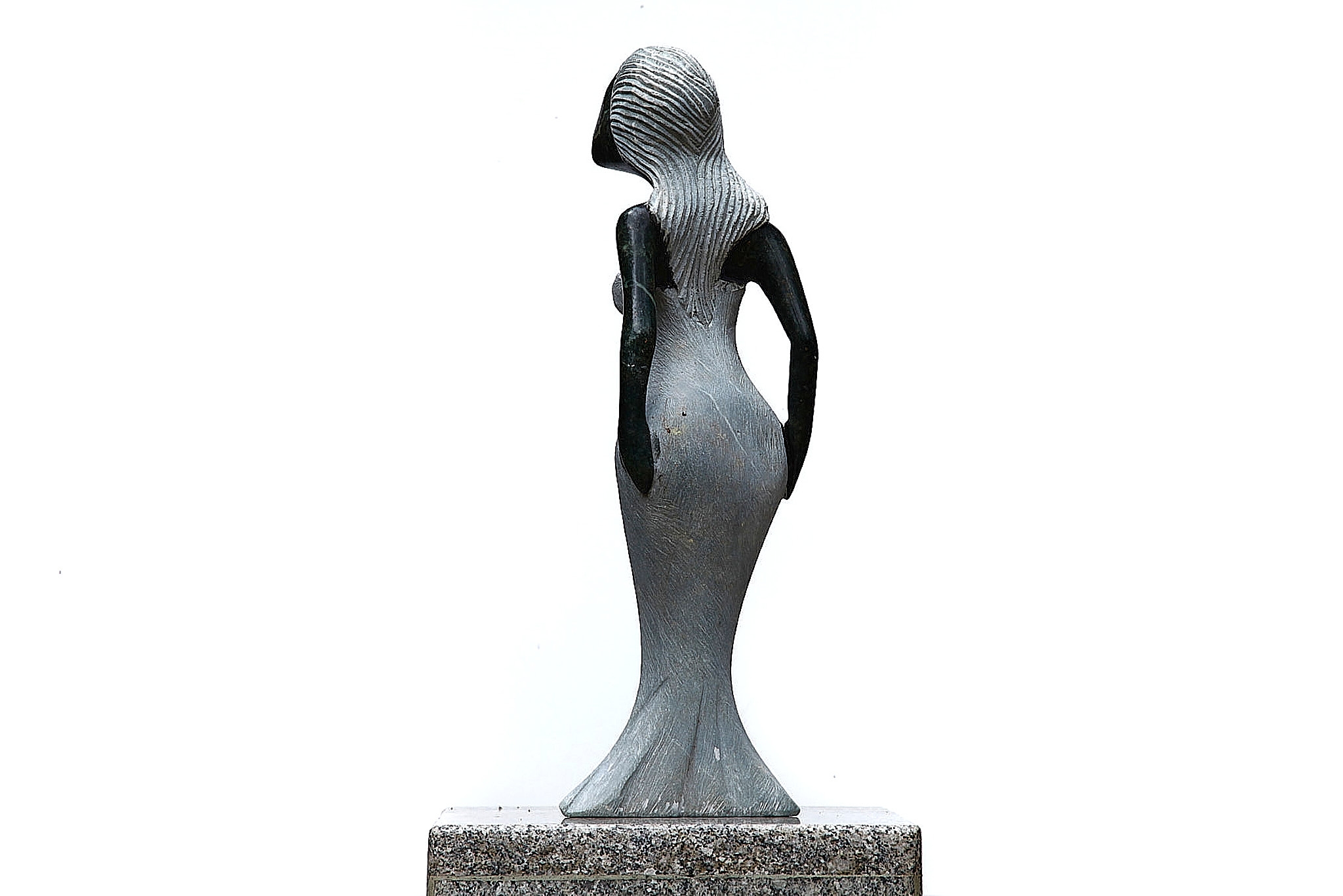 A Shona sculpture made of Opal stone of a woman in a dress.