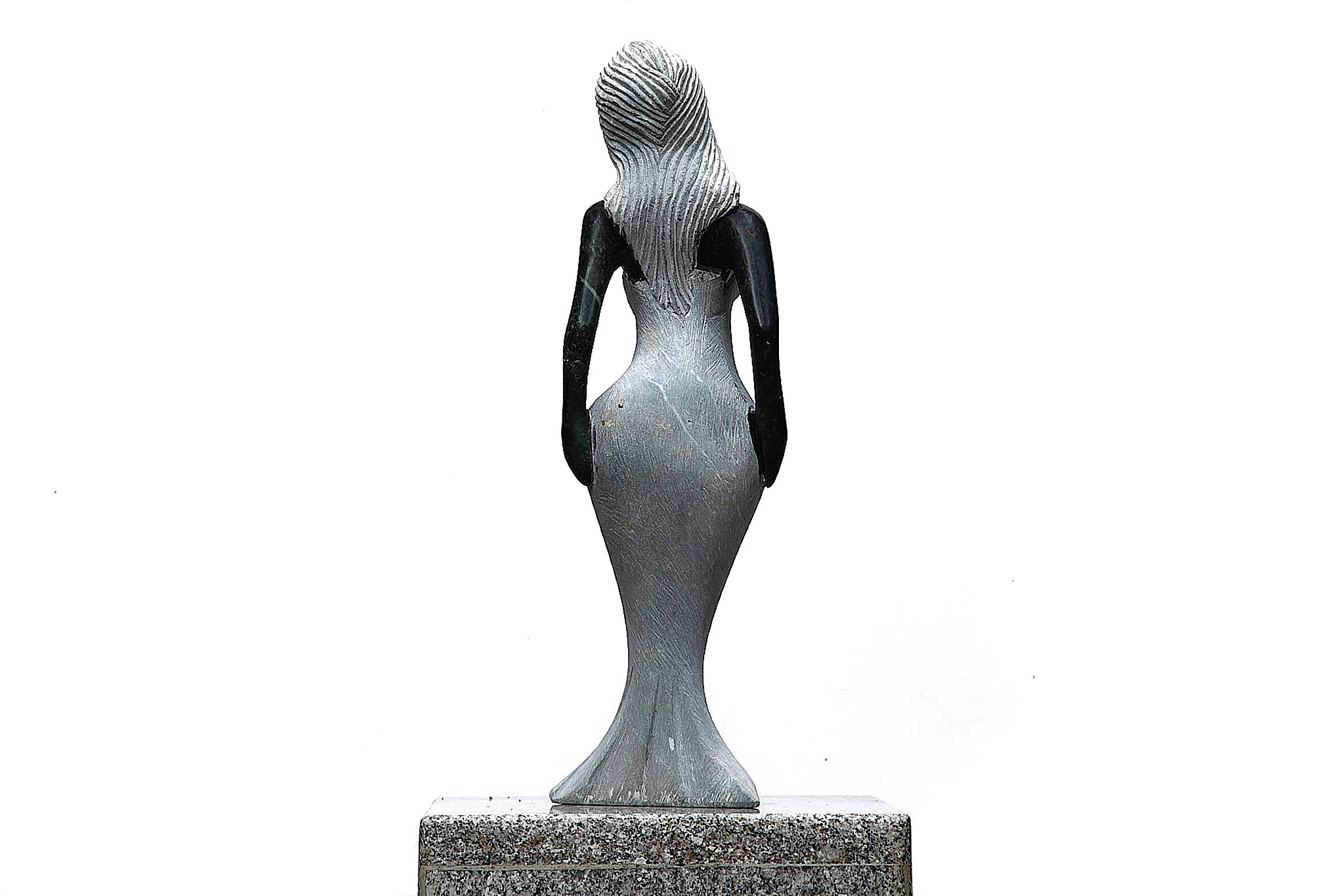 A Shona sculpture made of Opal stone of a woman in a dress.