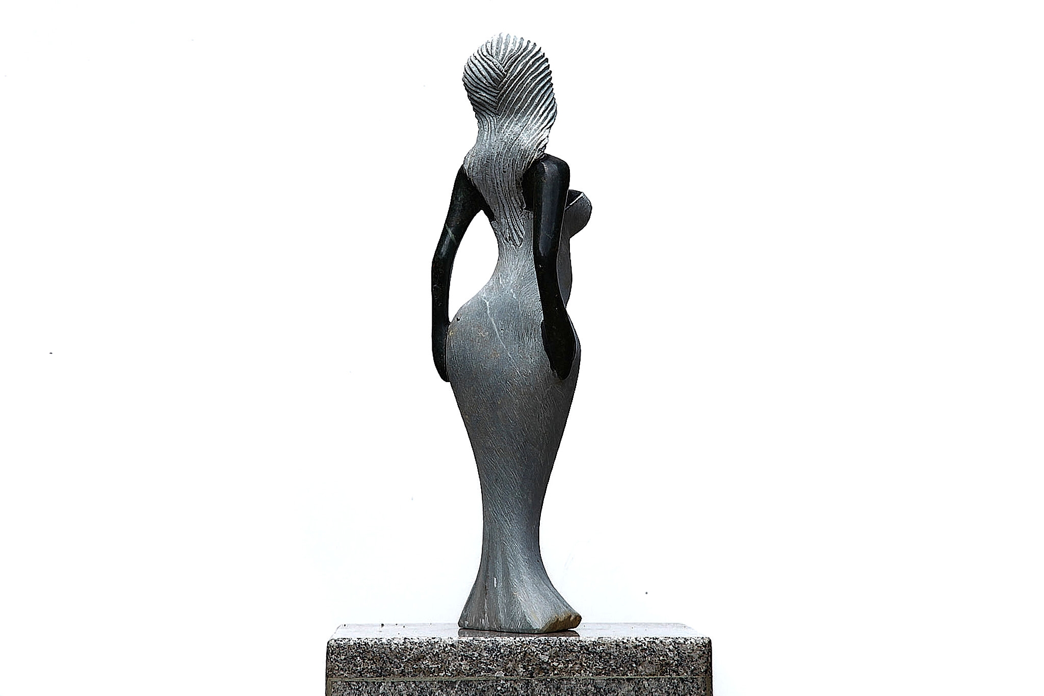 A Shona sculpture made of Opal stone of a woman in a dress.