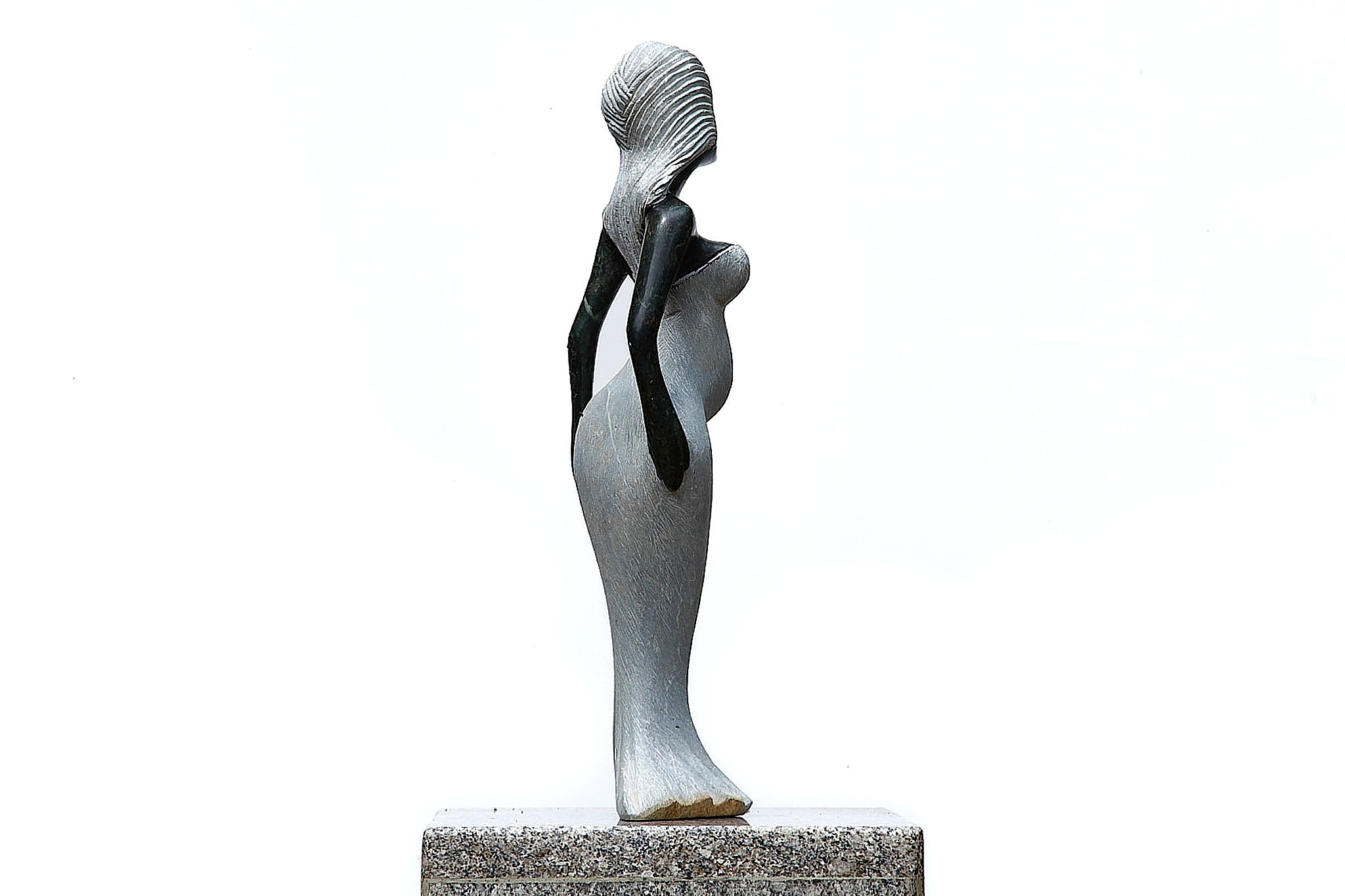 A Shona sculpture made of Opal stone of a woman in a dress.