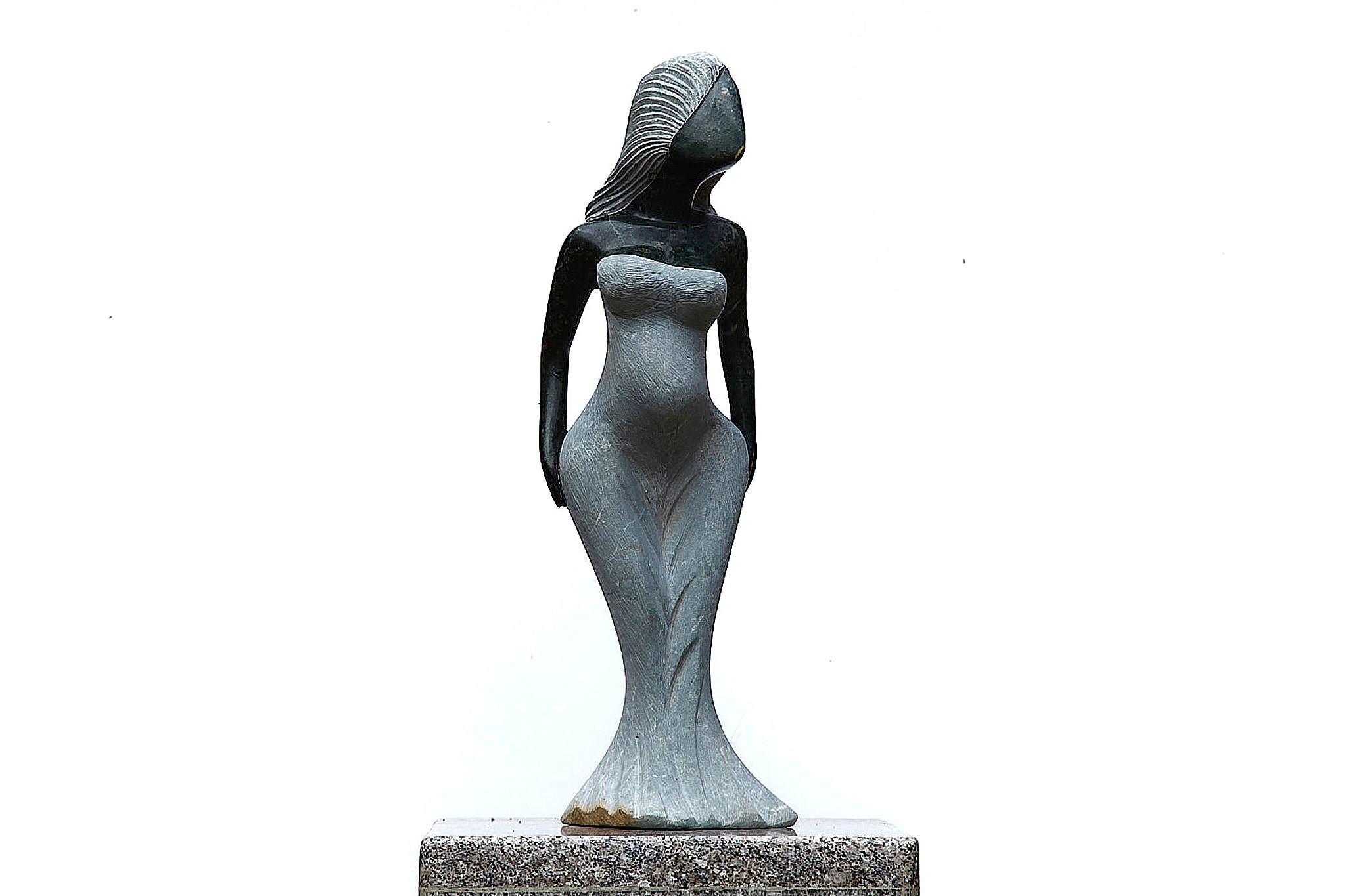 A Shona sculpture made of Opal stone of a woman in a dress.