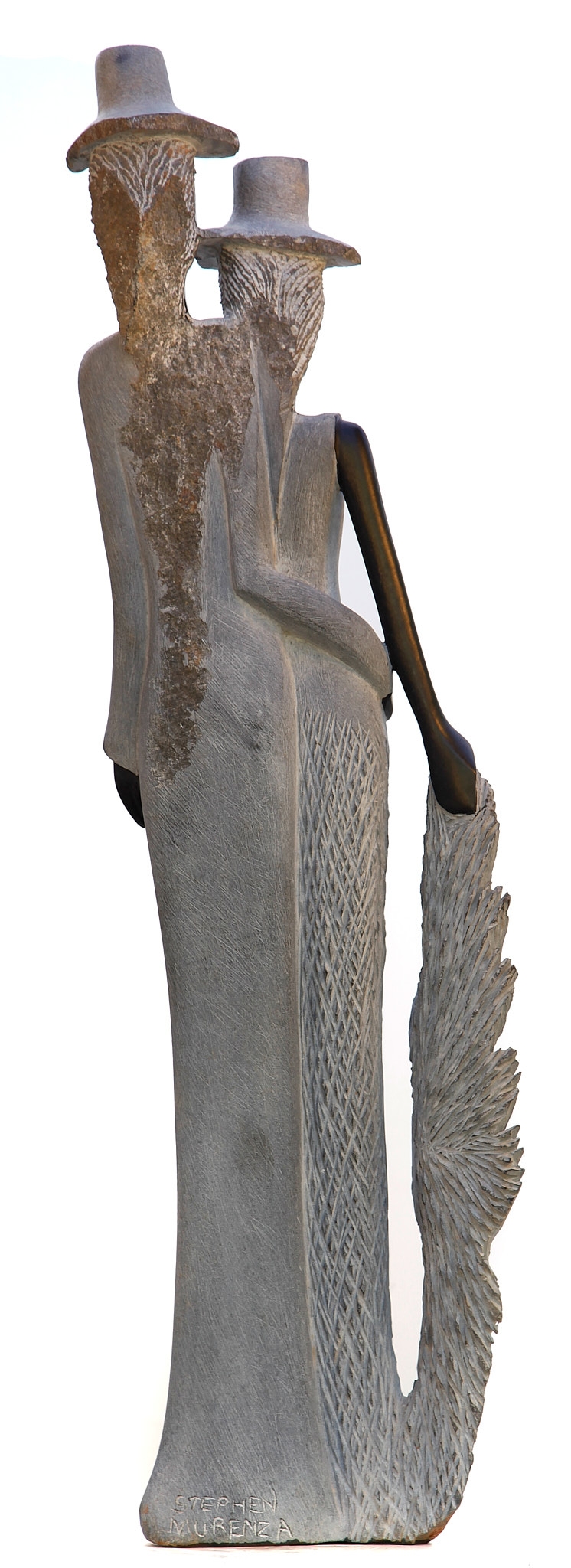 A figurative Shona sculpture of a man and a woman stood with each other.
