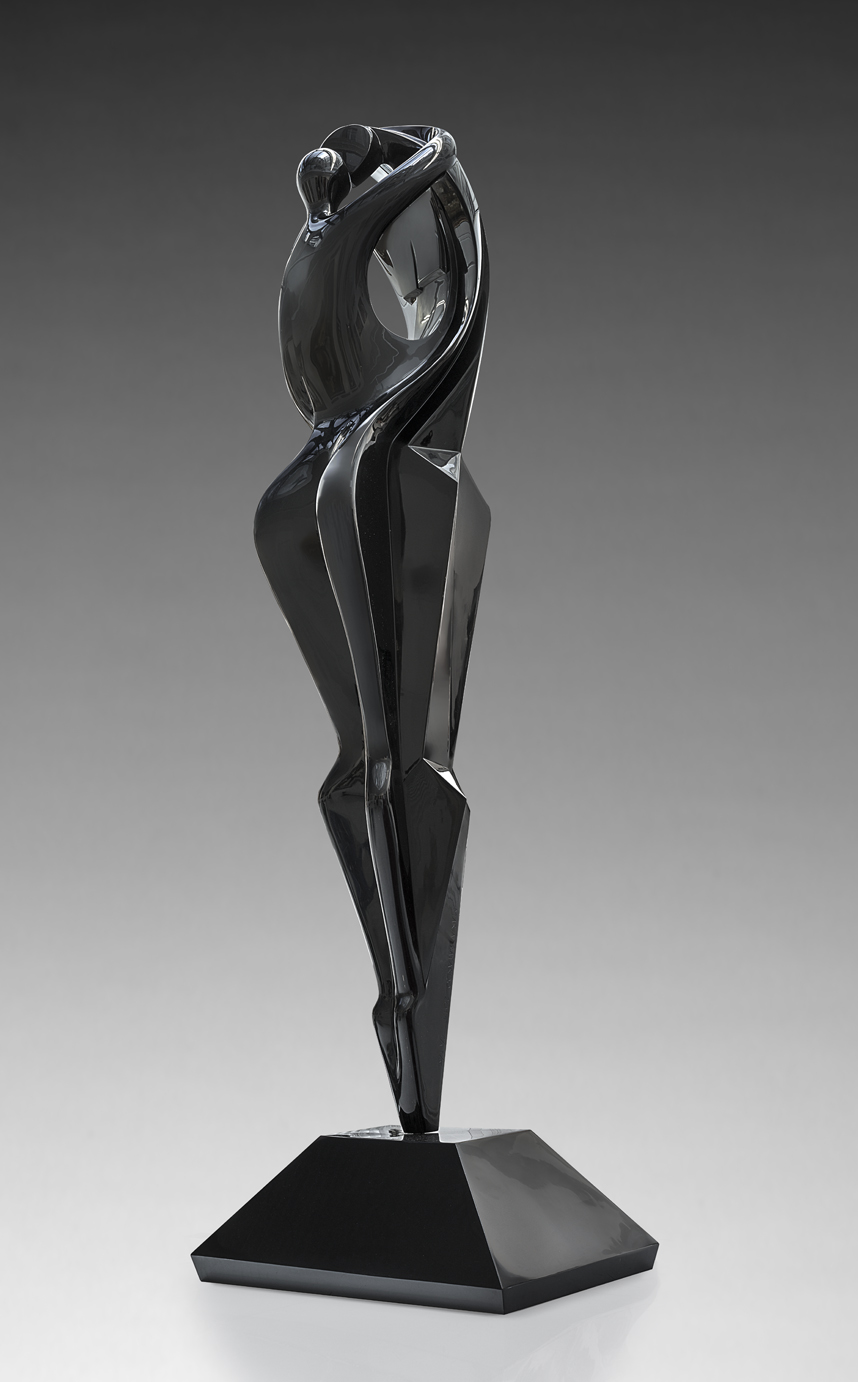 A figurative resin sculpture of a man and a woman holding each other in an embrace.
