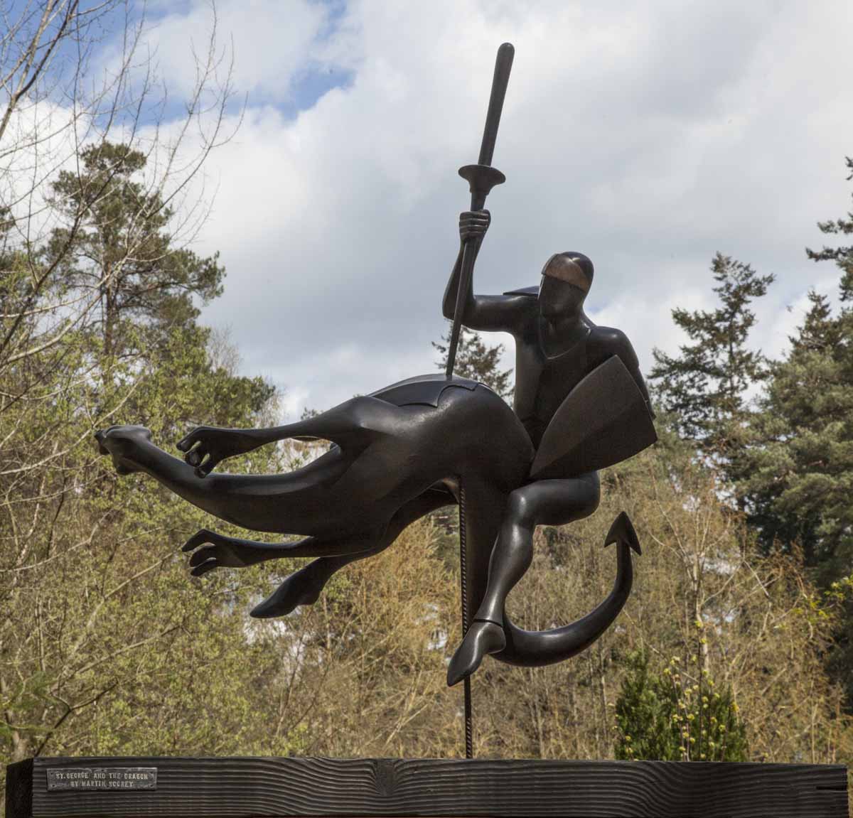 A figurative wooden sculpture of St George slaying the dragon.