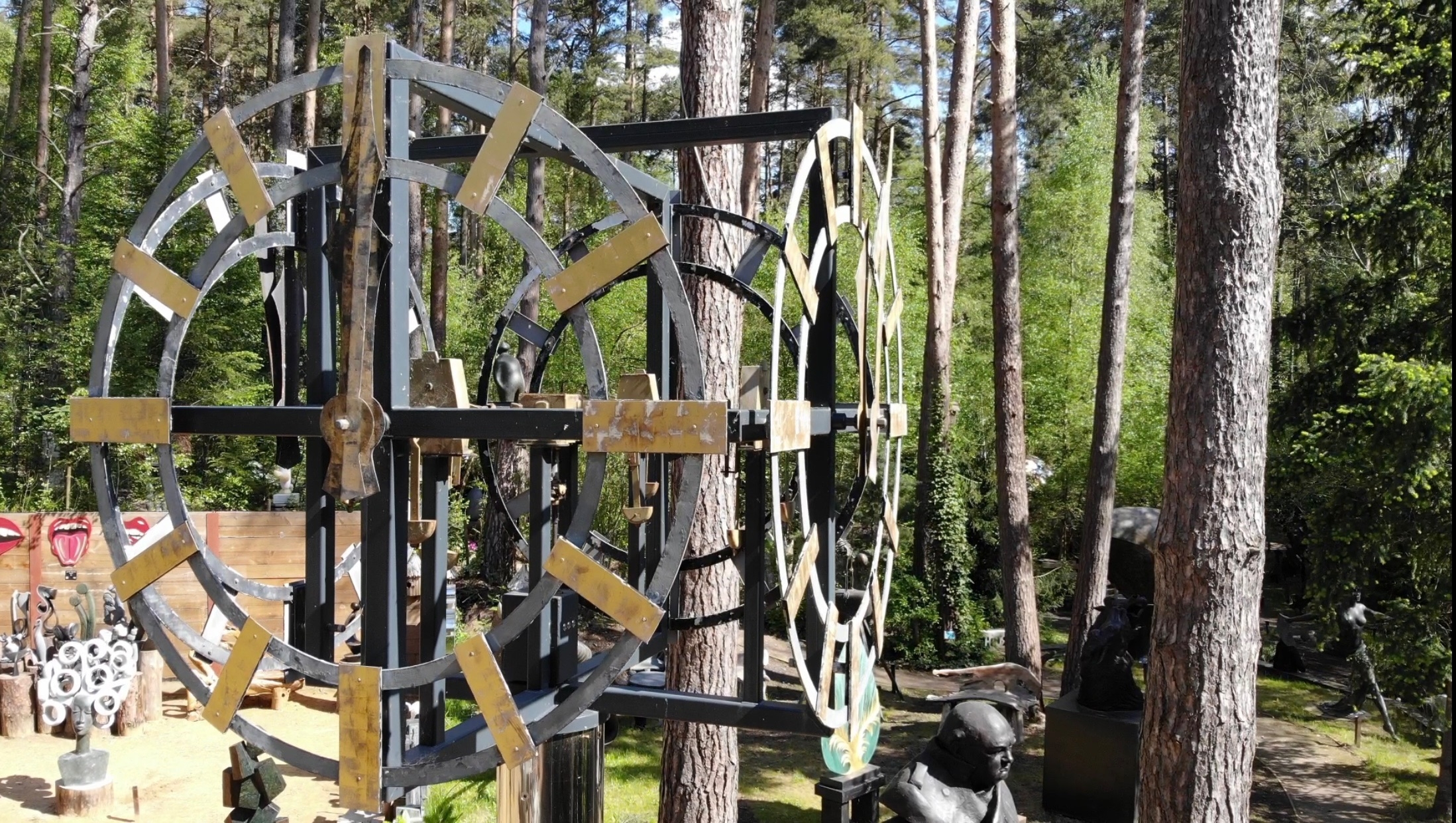 A monumental skeleton clock with gilt baton numerals and hands on an associated chromed steel column.