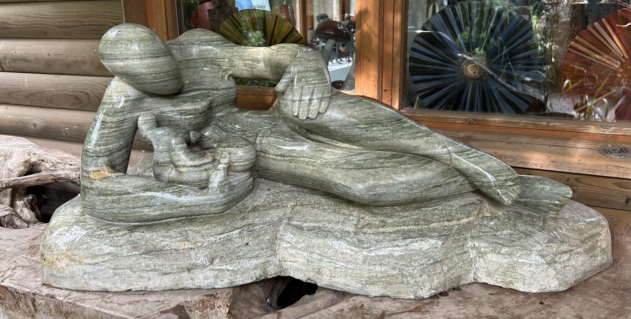 Large Bronze Sculpture of a Mother Cradling her baby and lying on her side