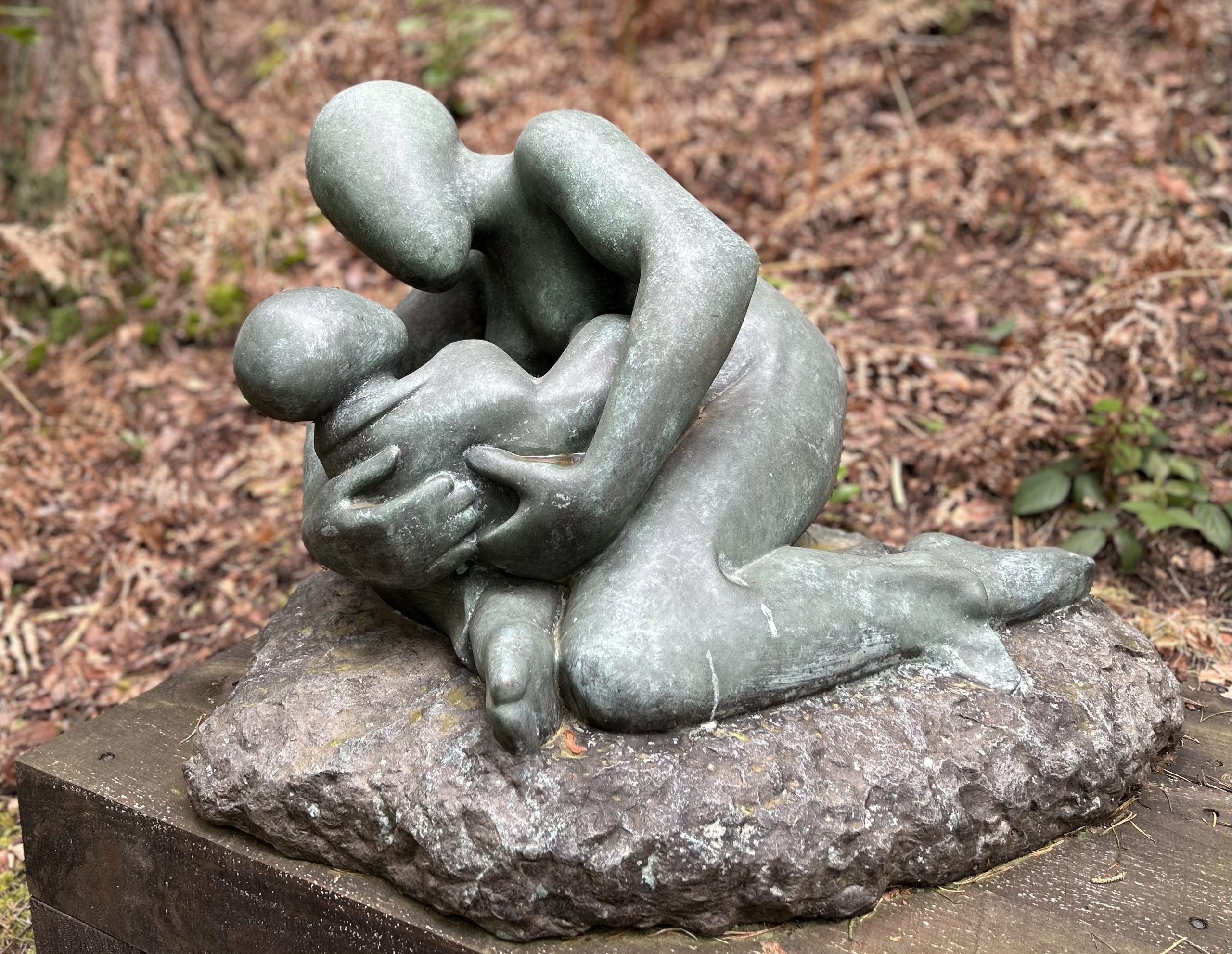 Large Bronze Sculpture of a Mother Cradling her baby and crouching down