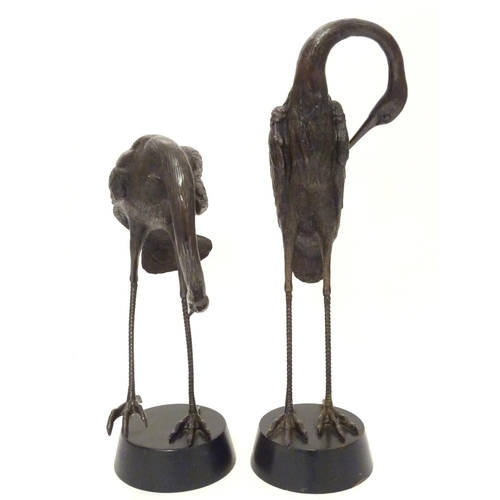 Pair of two bronze Cranes, One standing on one leg, the other standing on both legs.