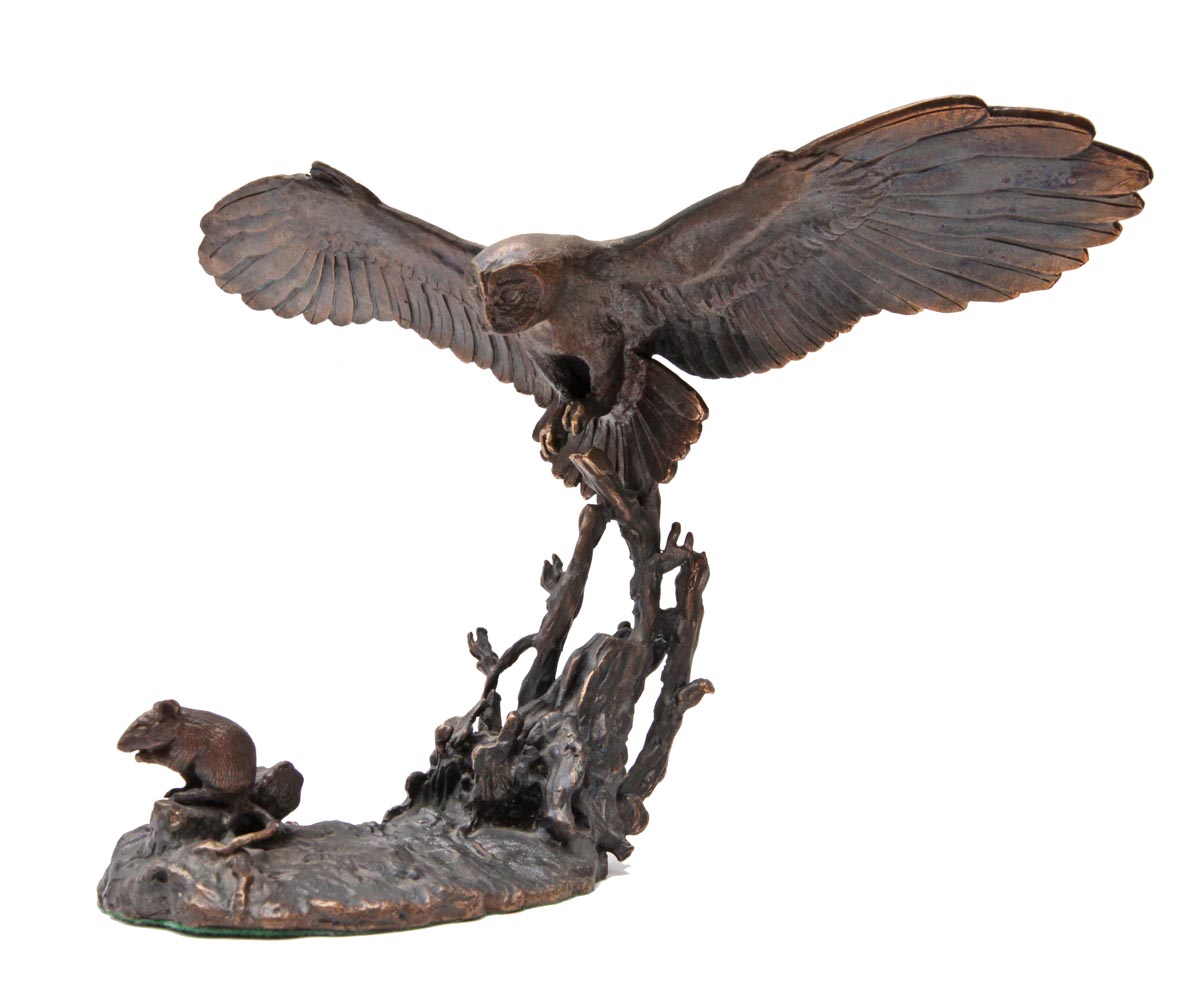 A figurative bronze sculpture of a tawny owl hunting down a mouse.