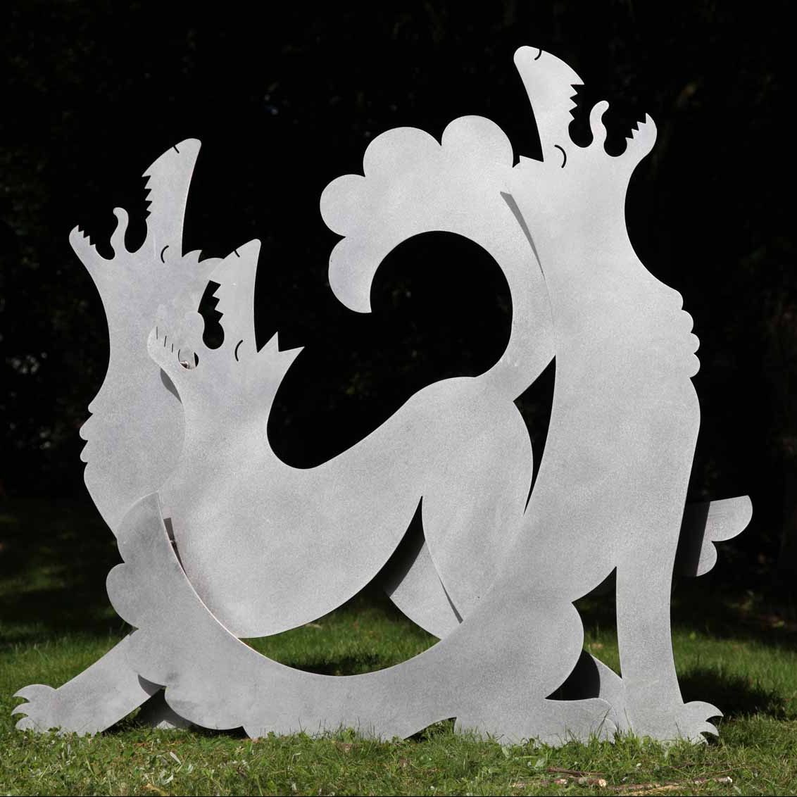 A figurative stainless steel sculpture of a pack of stylised wolves howling together.