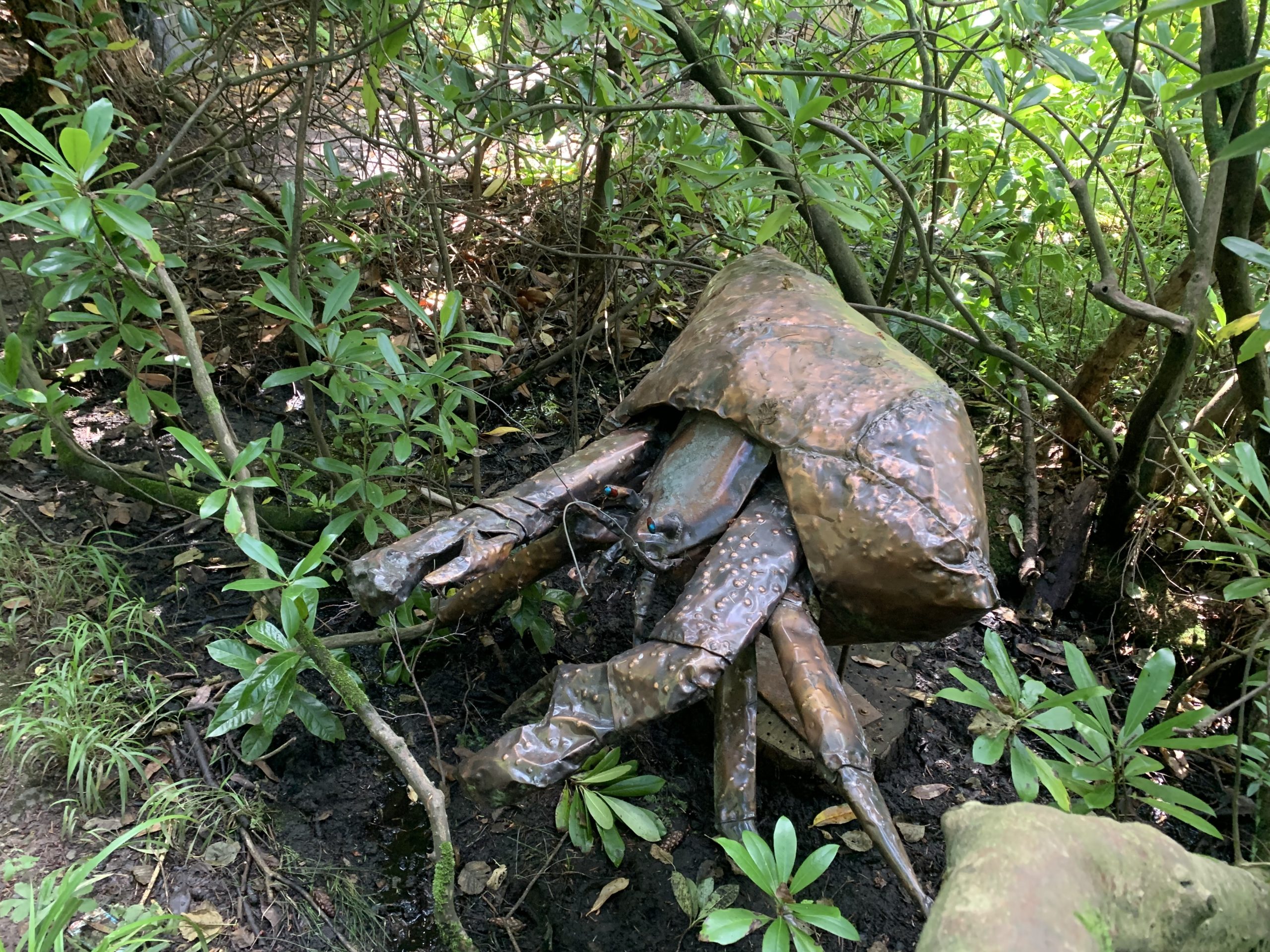 An abstract copper sculpture of a hermit crab.