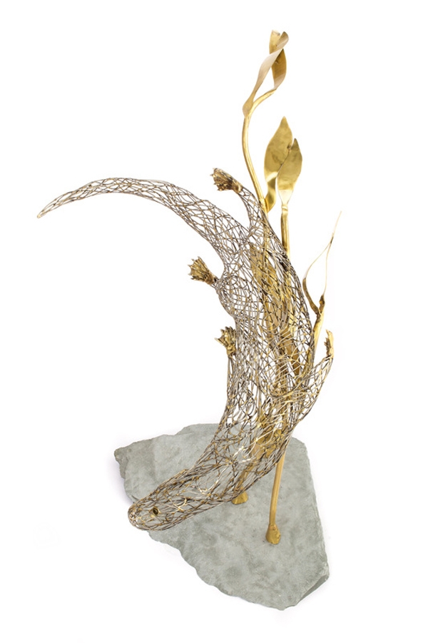 A figurative steel and brass sculpture of an Otter swimming through reeds and water.
