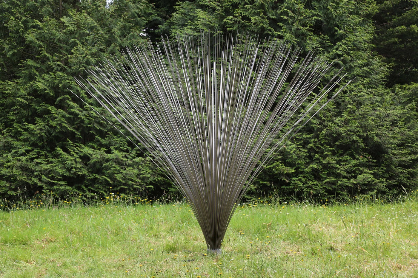 A abstract stainless steel sculpture of a collection of rods that fan out from the centre.