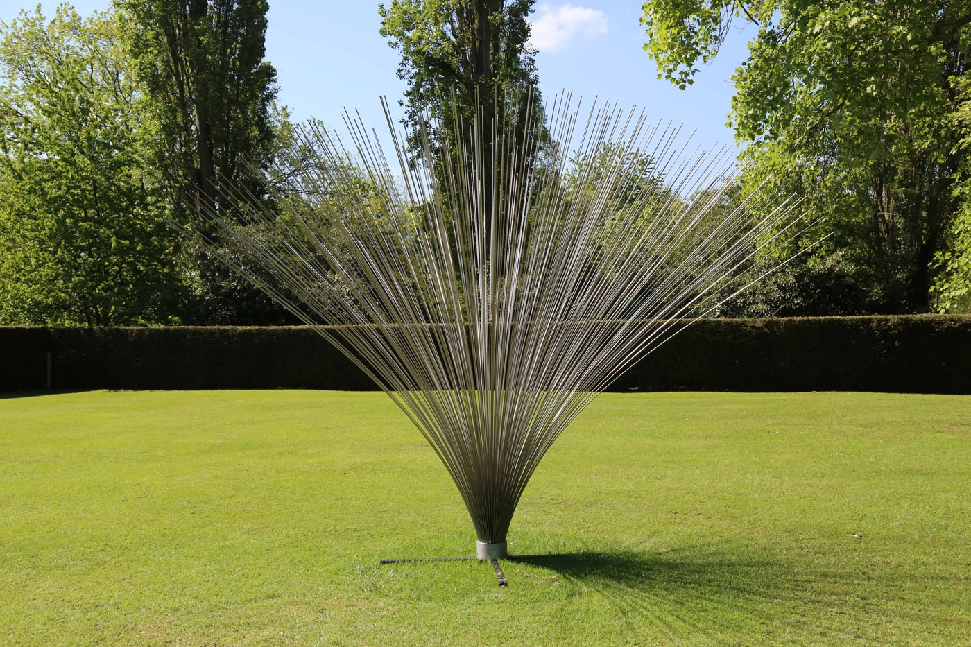 A abstract stainless steel sculpture of a collection of rods that fan out from the centre.