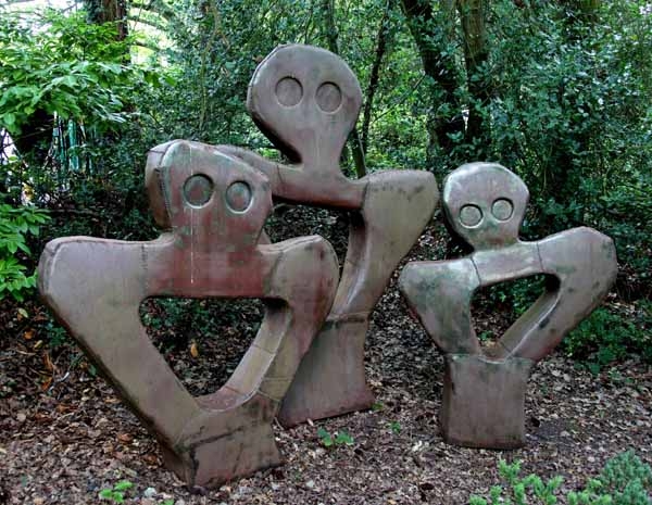 A abstract mild steel sculpture of a group of figures together as a family.