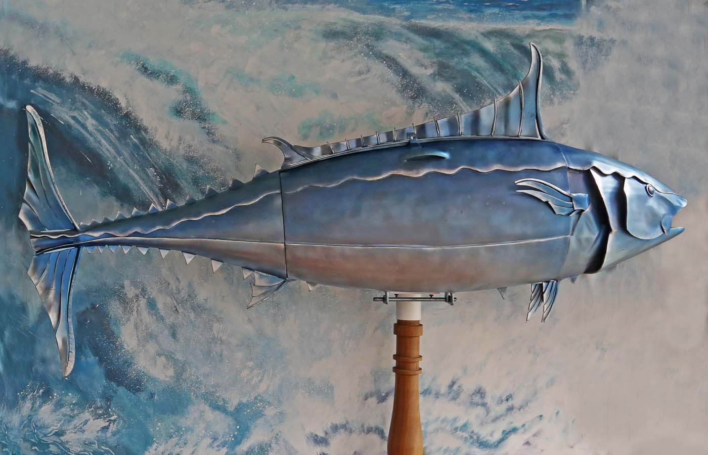 A figurative steel and wood sculpture of a drinks cabinet in the shape of a tuna fish.