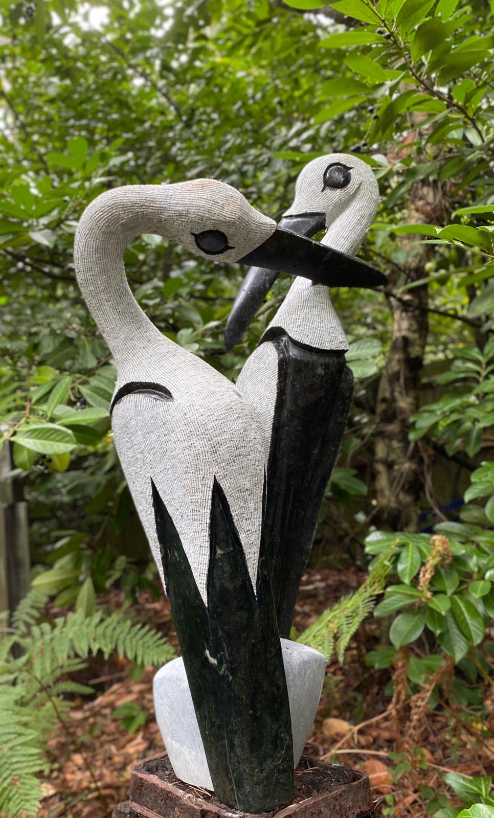 Secret of a Happy Marriage is a Black and white shona stone sculpture of two birds facing other