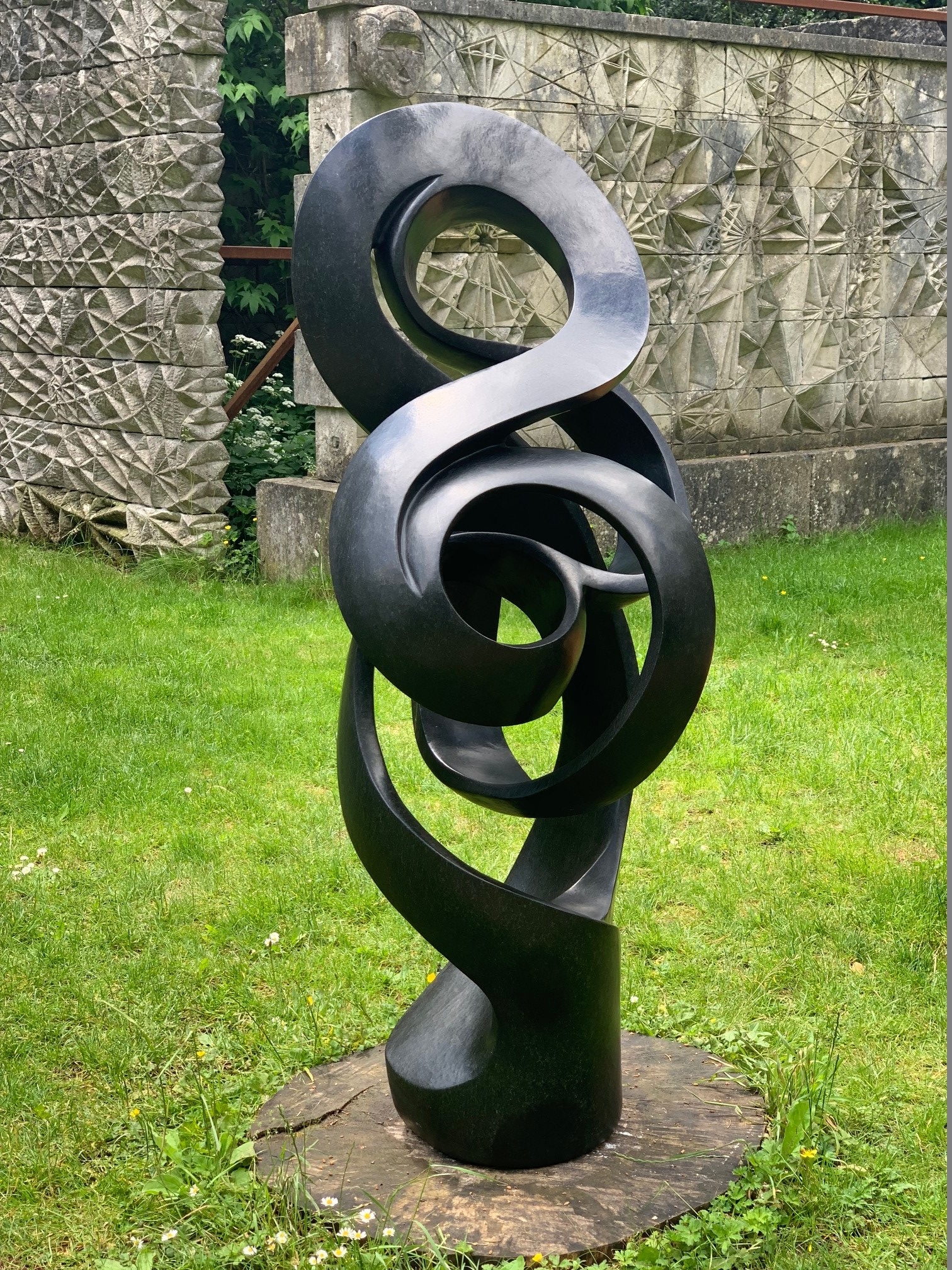 A shona stone sculpture of an abstract shape that curves and twists around.