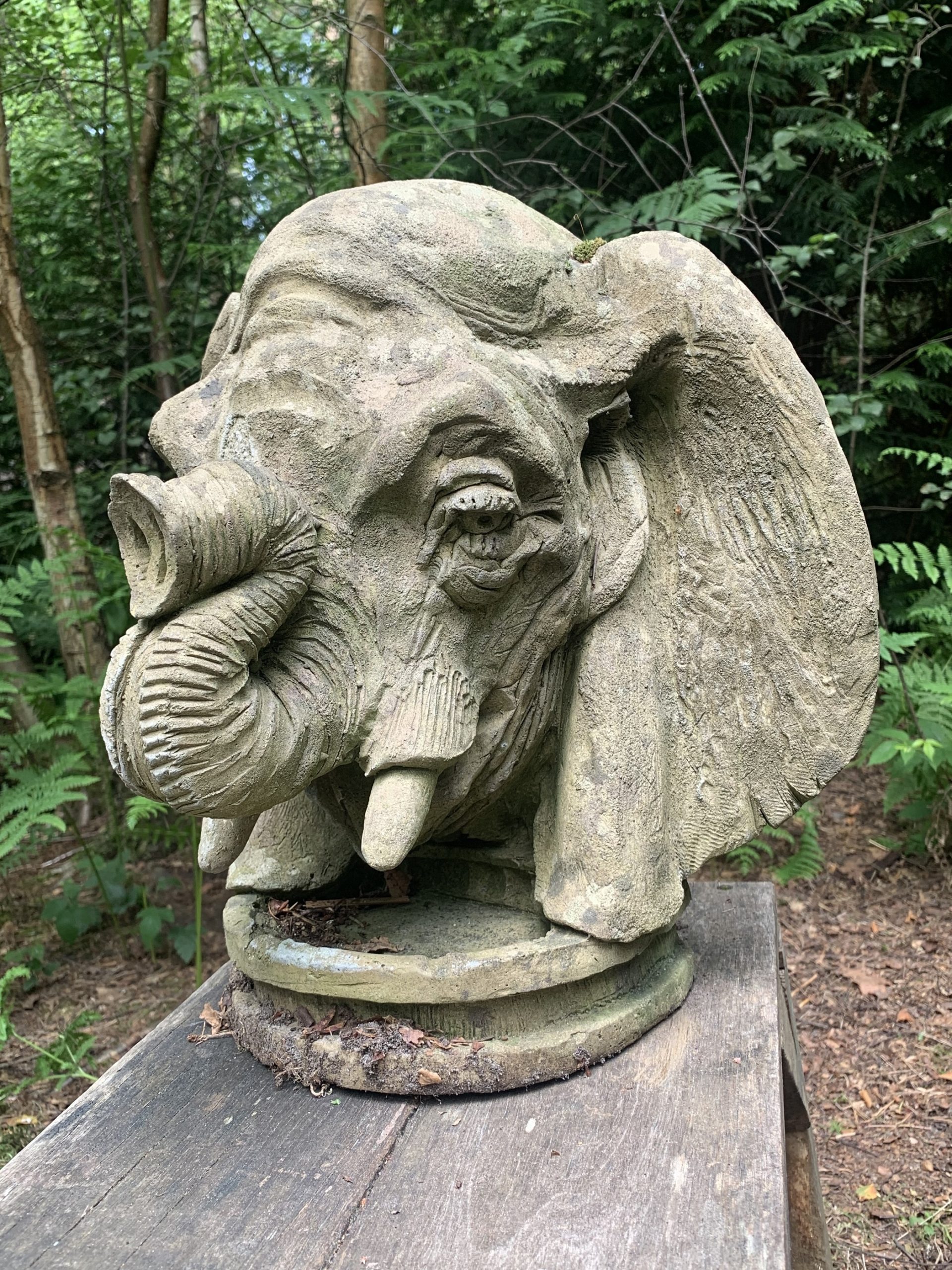 A realism stone resin sculpture of an elephants head.