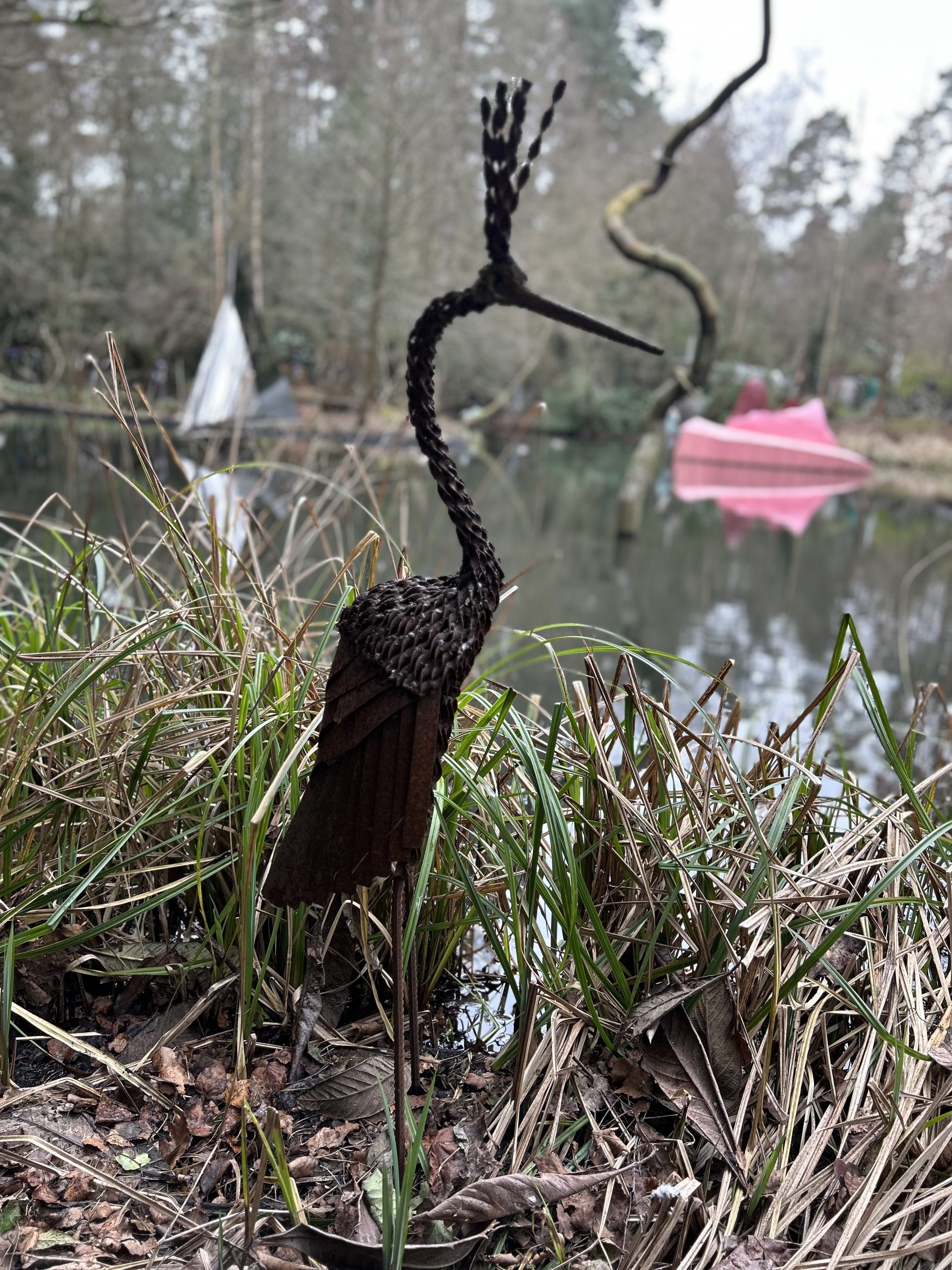 A metal animal sculpture of a stork.