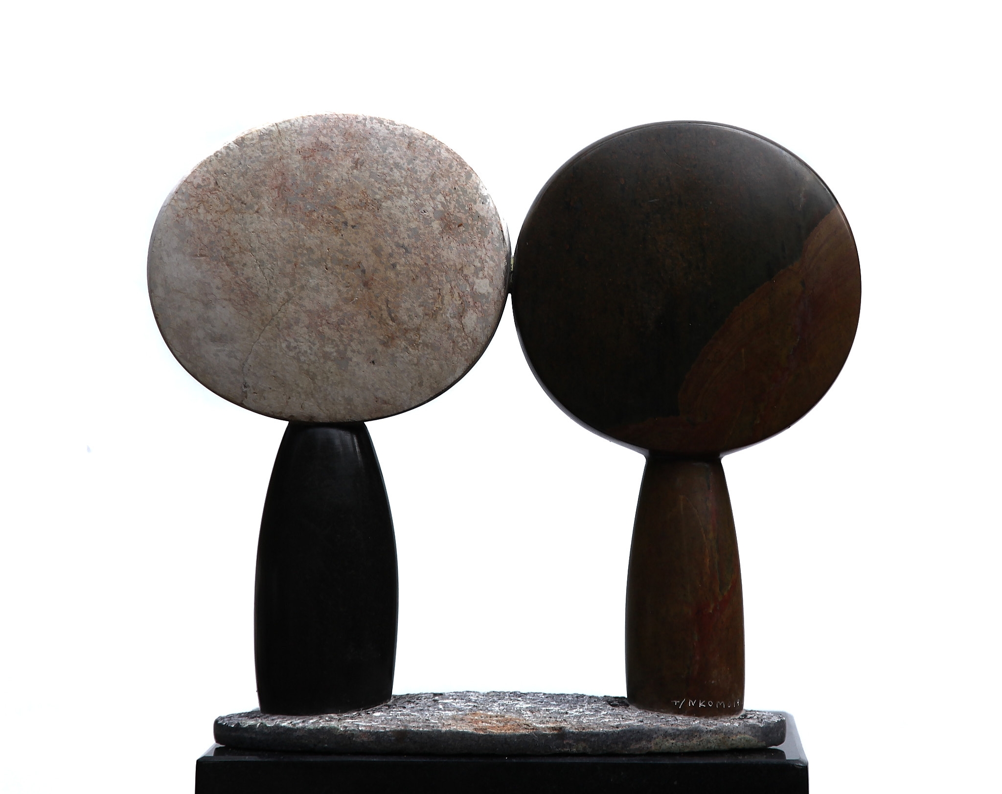 A Shona sculpture showing two abstract figures with large round heads.