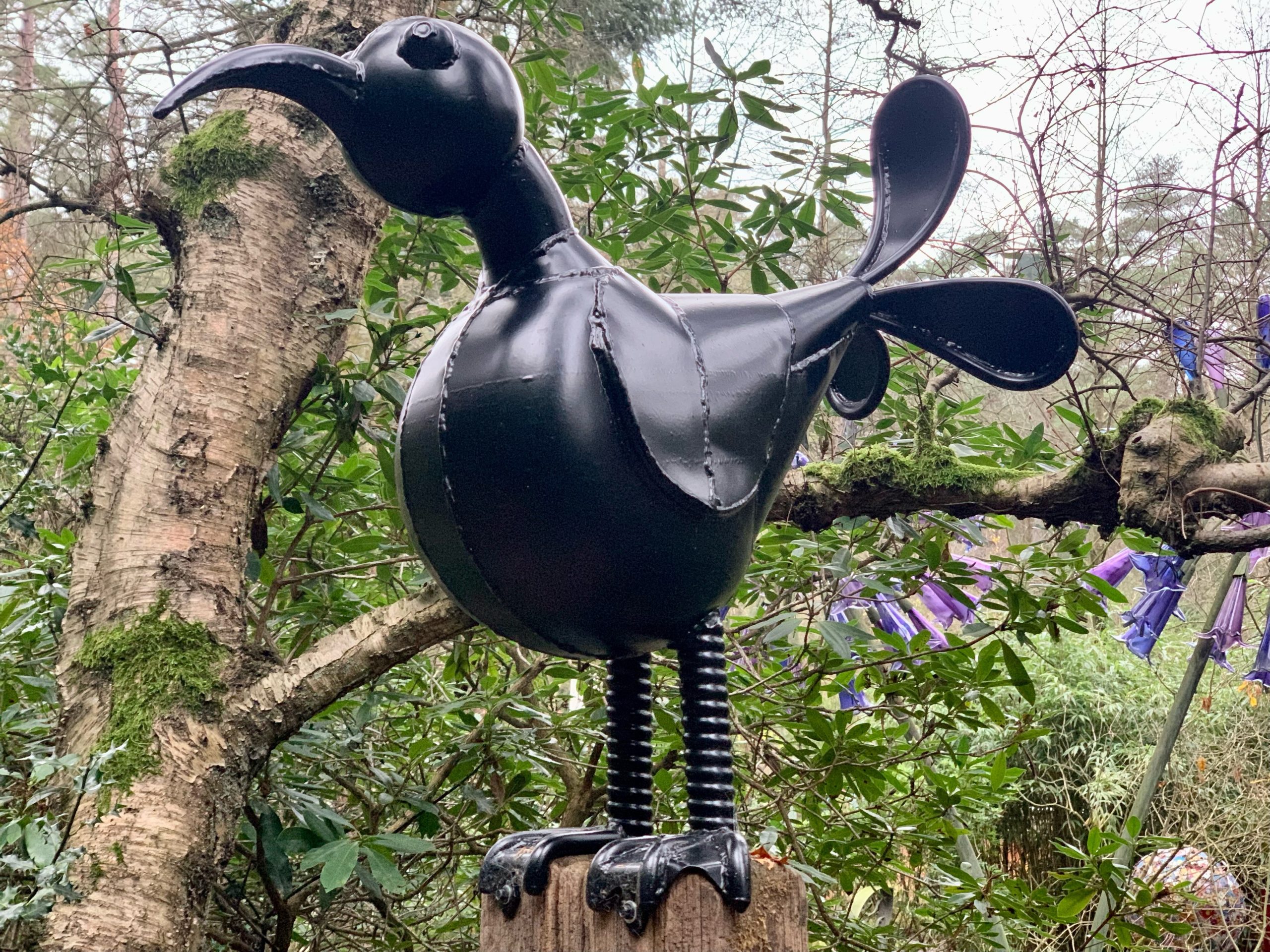 Abstract and Fun Sculpture of a Bird Made from Found Objects Standing on a Tall Plinth