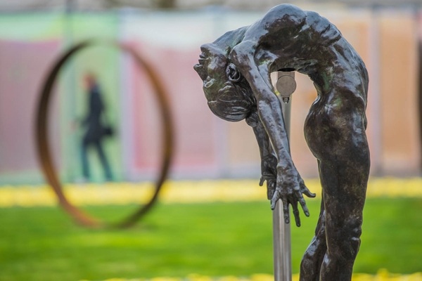 I Spirit by Teresa Wells is a Life size bronze sculpture of a female figure suspended in the air, with her spine arched over and head thrown back