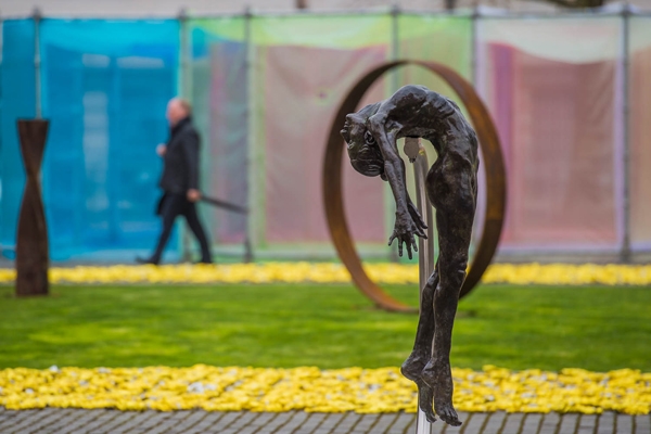 I Spirit by Teresa Wells is a Life size bronze sculpture of a female figure suspended in the air, with her spine arched over and head thrown back