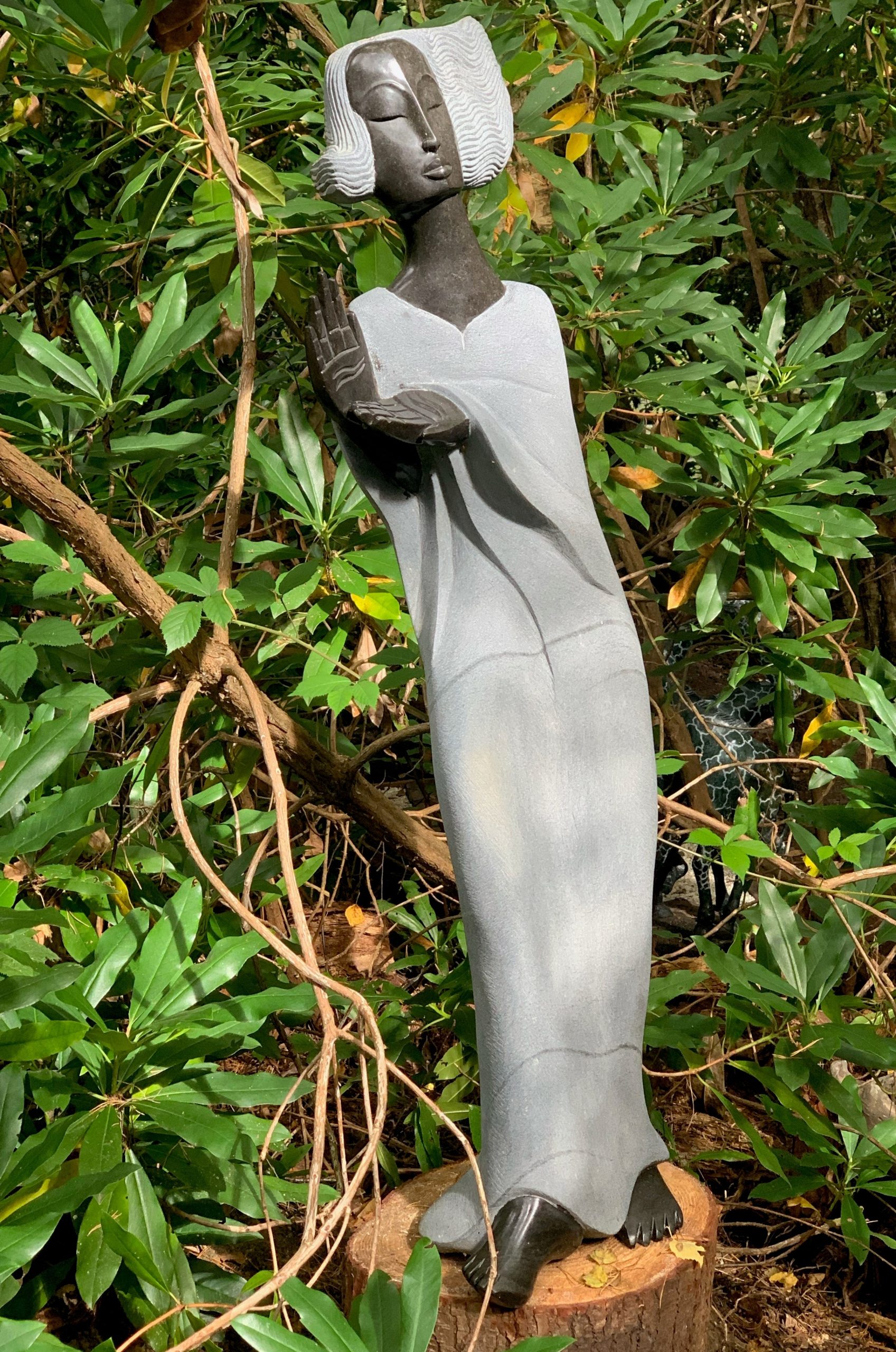 A Shona sculpture of a tall woman figure made of Springstone.