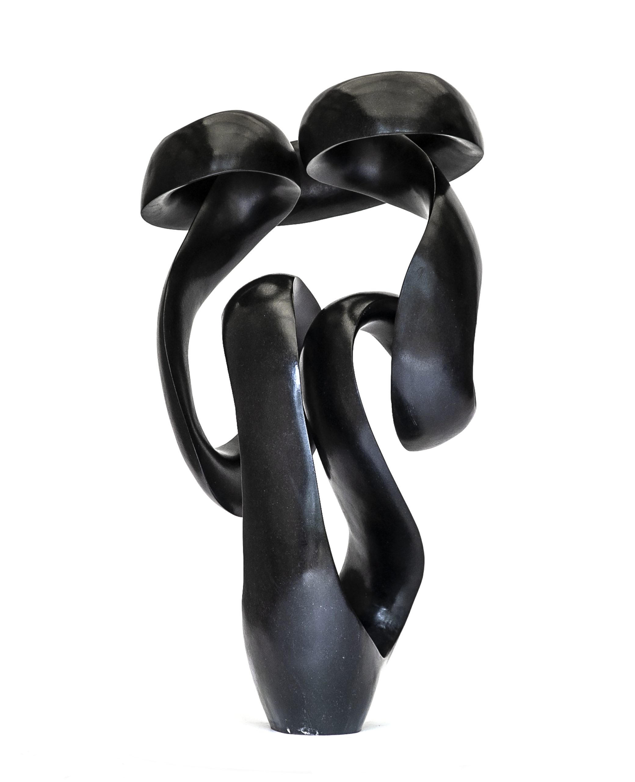 A shona springstone sculpture of an twisting and curing abstract shape.