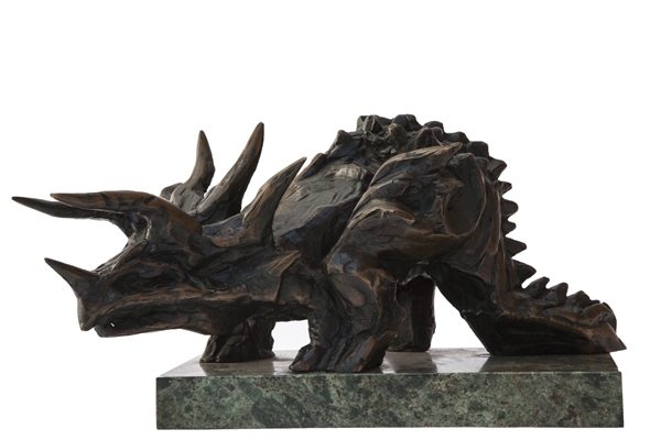 A figurative bronze sculpture of an expressionism triceratops mounted onto a green marble base.
