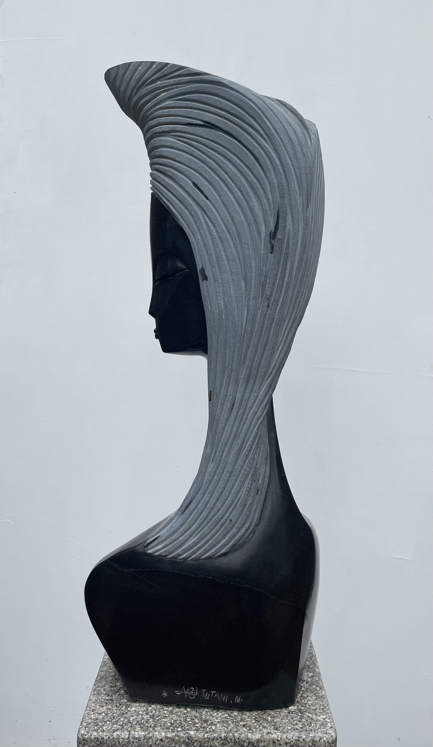 A Shona sculpture of a woman's head and shoulders.